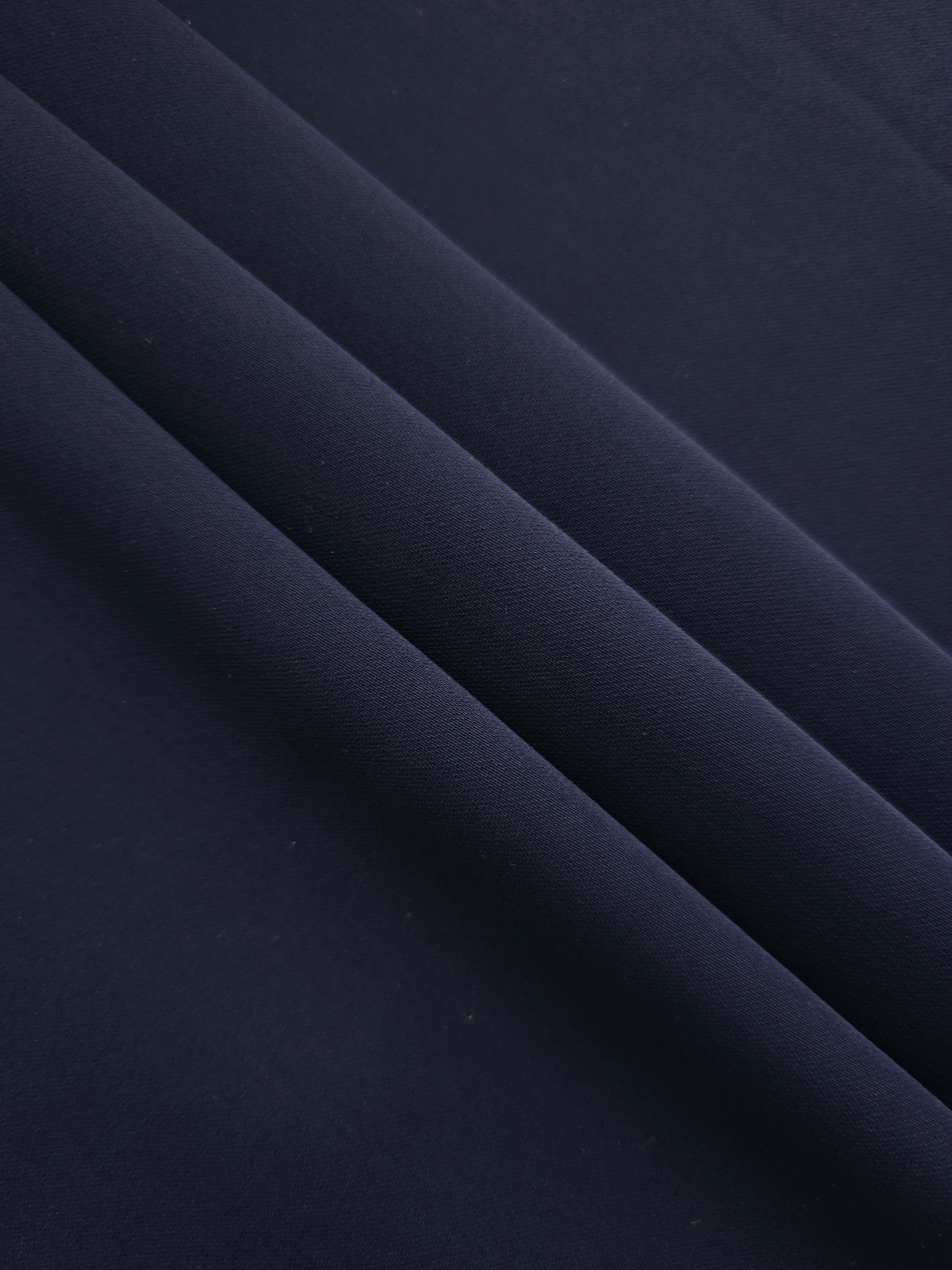 Layered Midnight Marine Silky Italian Crepe showing soft structure in layered folds, suitable for draped dresses, elegant tops and modest fashion.