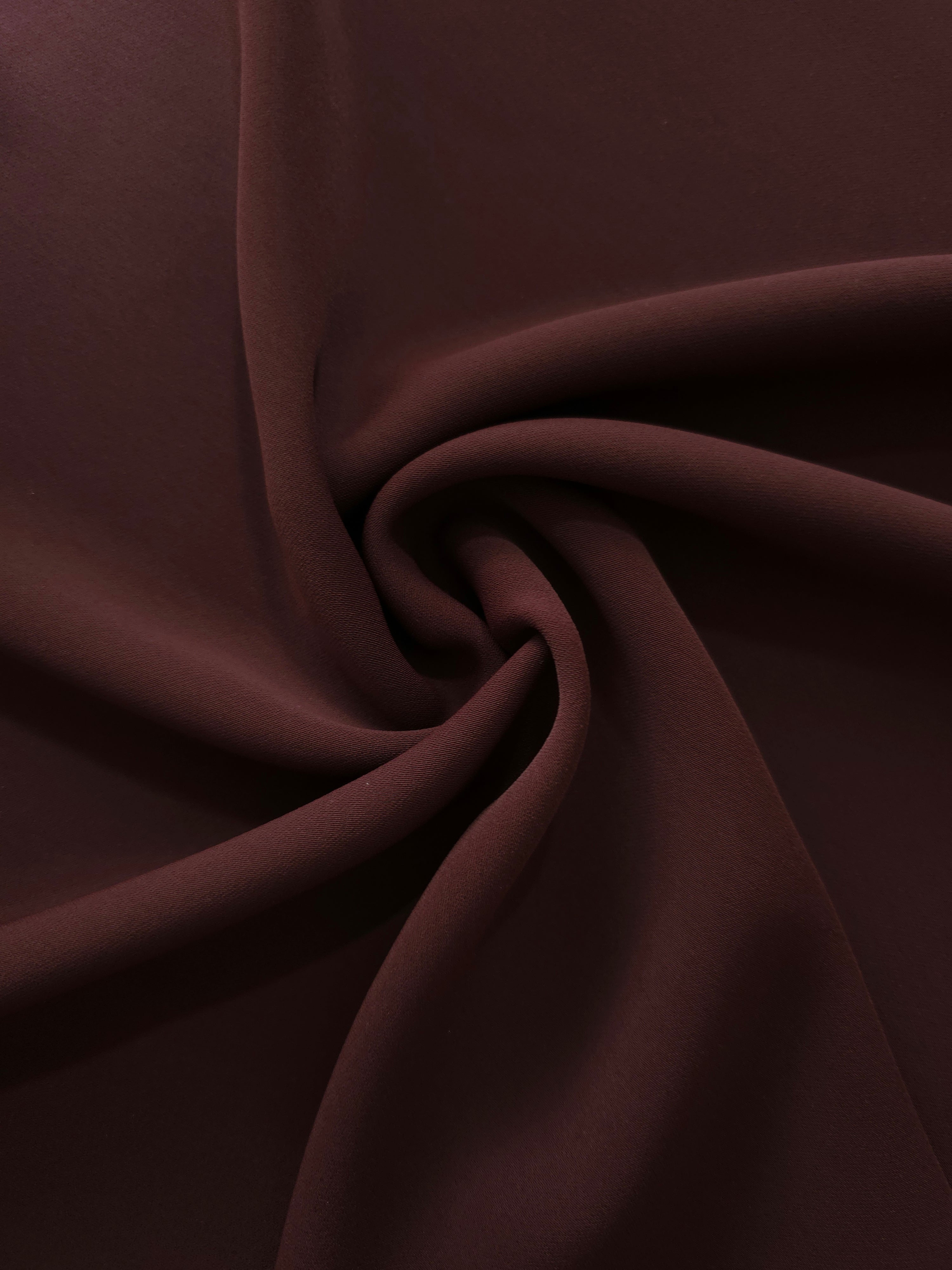 Swirled Mulberry Merlot Silky Italian Crepe showing flowing movement in a swirl drape, versatile for blouses, midi skirts and modest dresses.