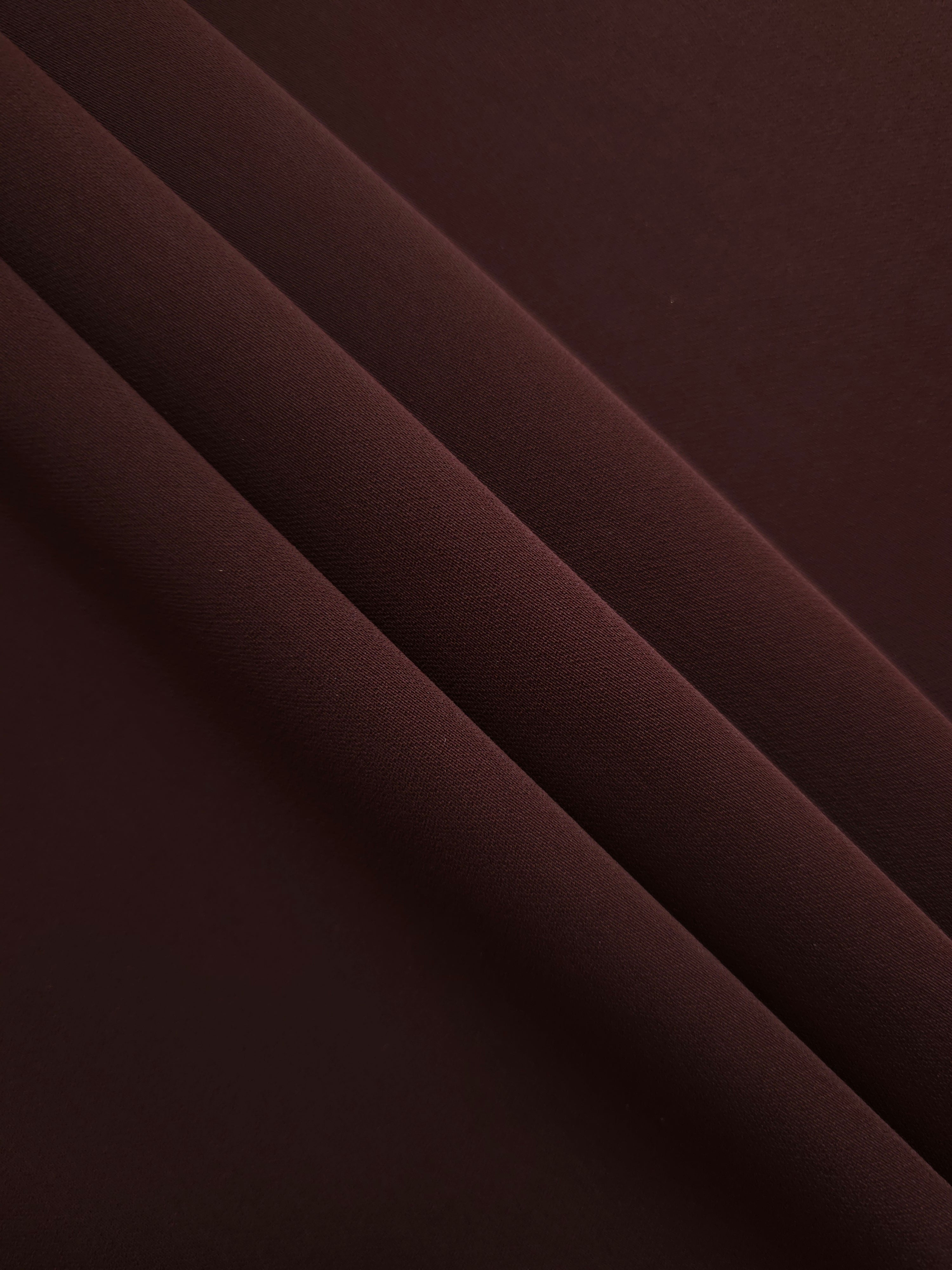 Layered Mulberry Merlot Silky Italian Crepe showing soft structure in layered folds, suitable for abayas, tunics and elegant shirt dresses.