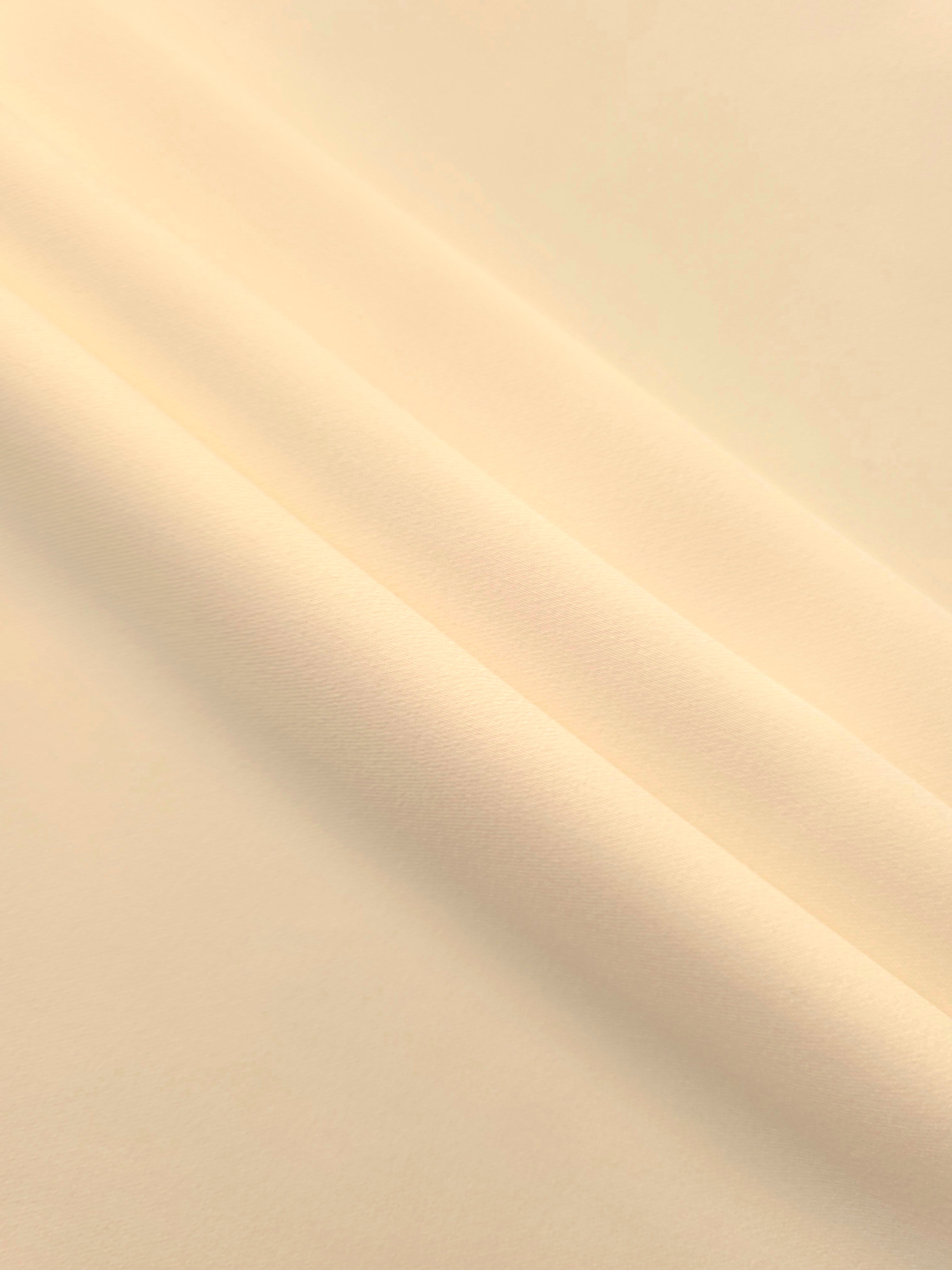 Layered Oat Almond Cream Silky Italian Crepe showing soft structure in layered folds, suitable for occasion gowns, tunics and lightweight tailored pieces.