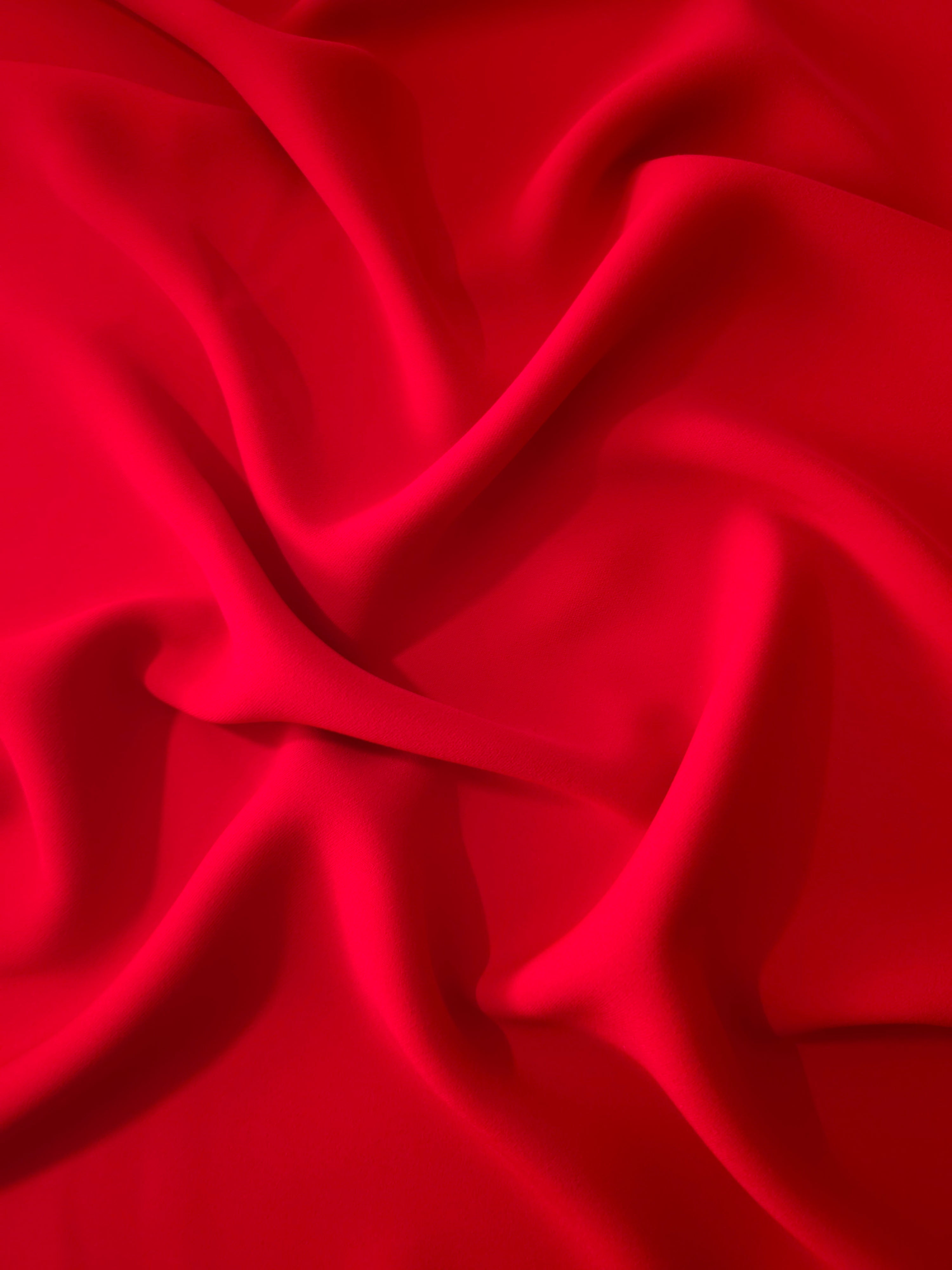 Draped Poppy Scarlet Silky Italian Crepe showing an elegant fall through draped folds, ideal for wrap dresses, wide-leg trousers and dressy co-ords.