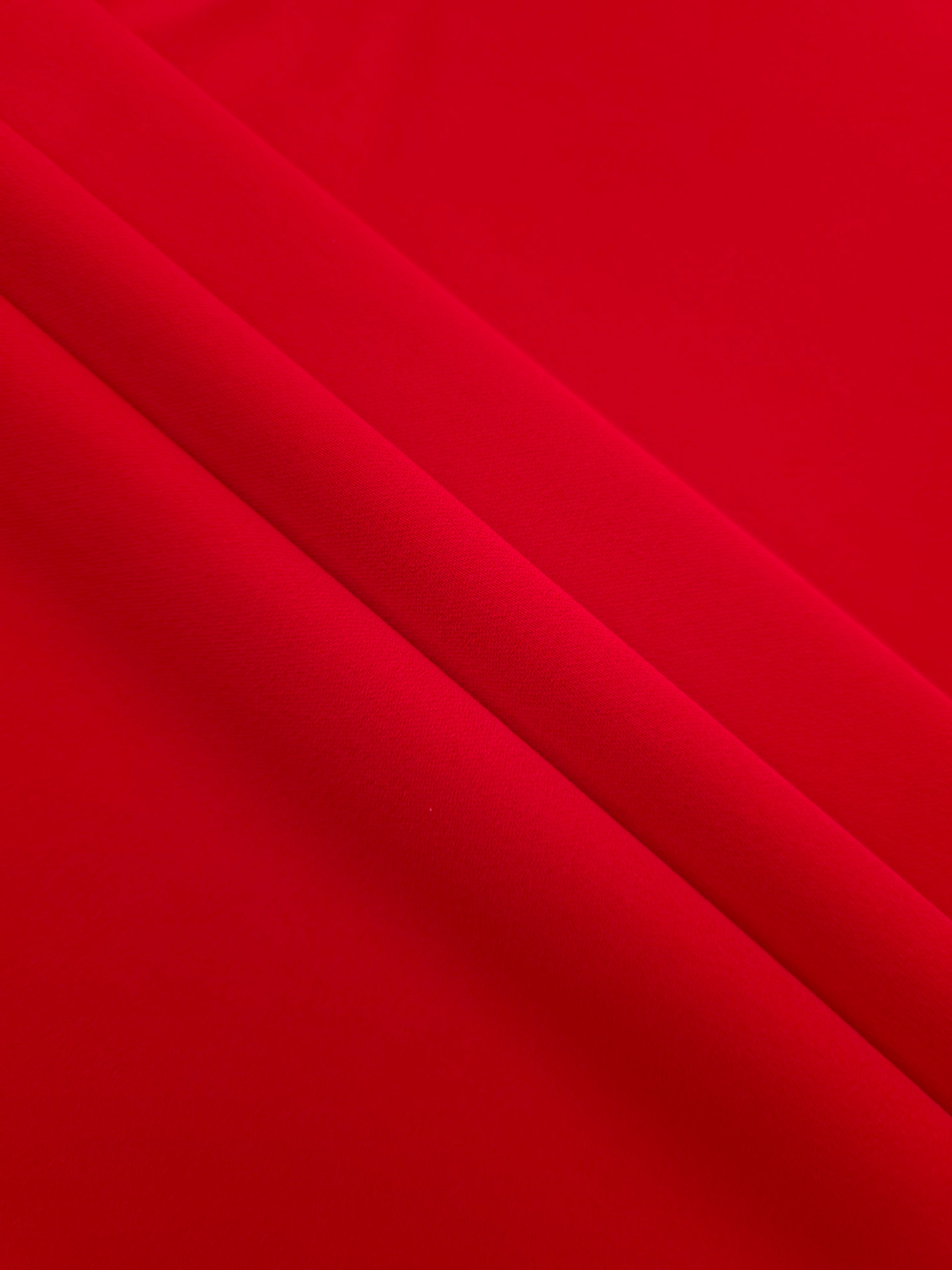 Layered Poppy Scarlet Silky Italian Crepe showing soft structure in layered folds, suitable for office blouses, tailored dresses and soft jackets.