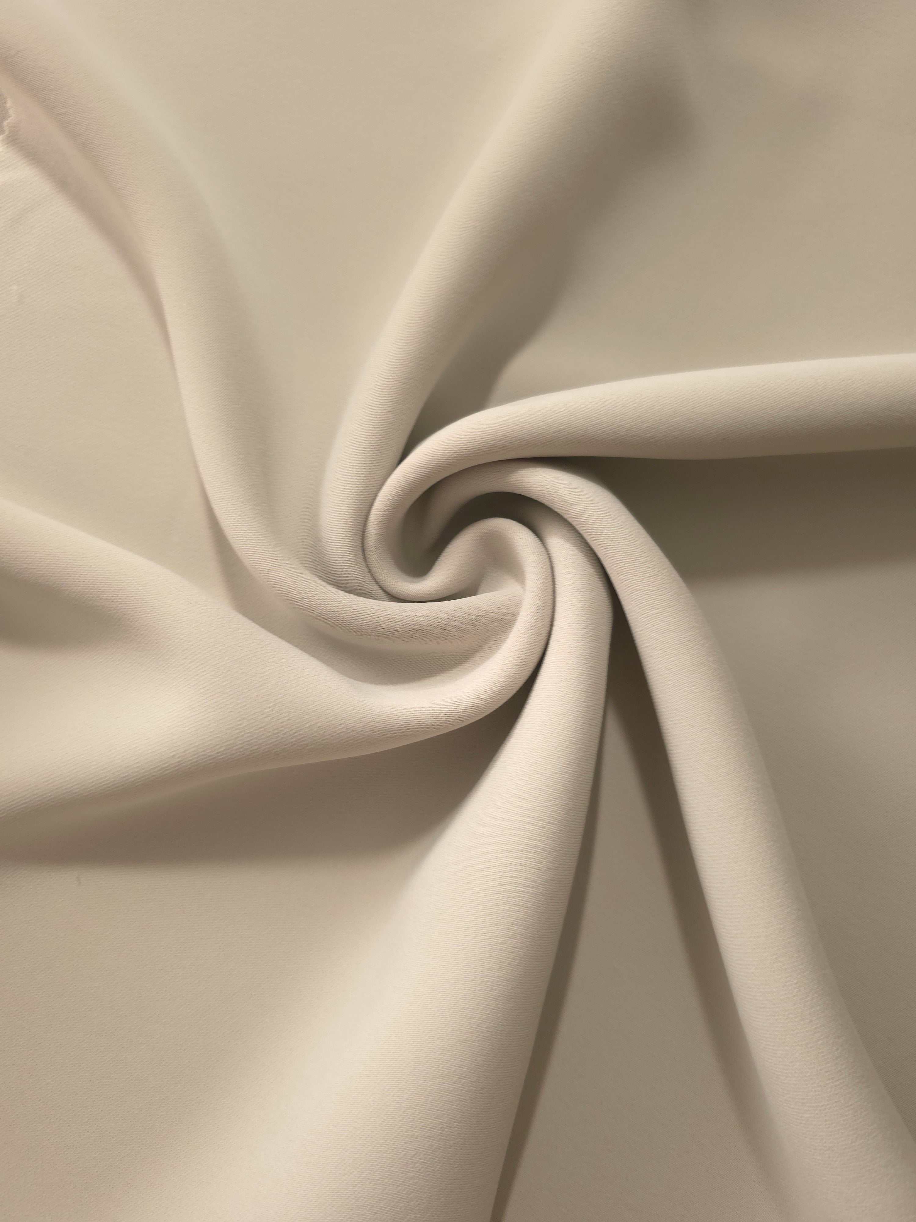 Swirled Porcelain Greige Silky Italian Crepe showing flowing movement in a swirl drape, versatile for cocktail dresses, skirts and polished separates.