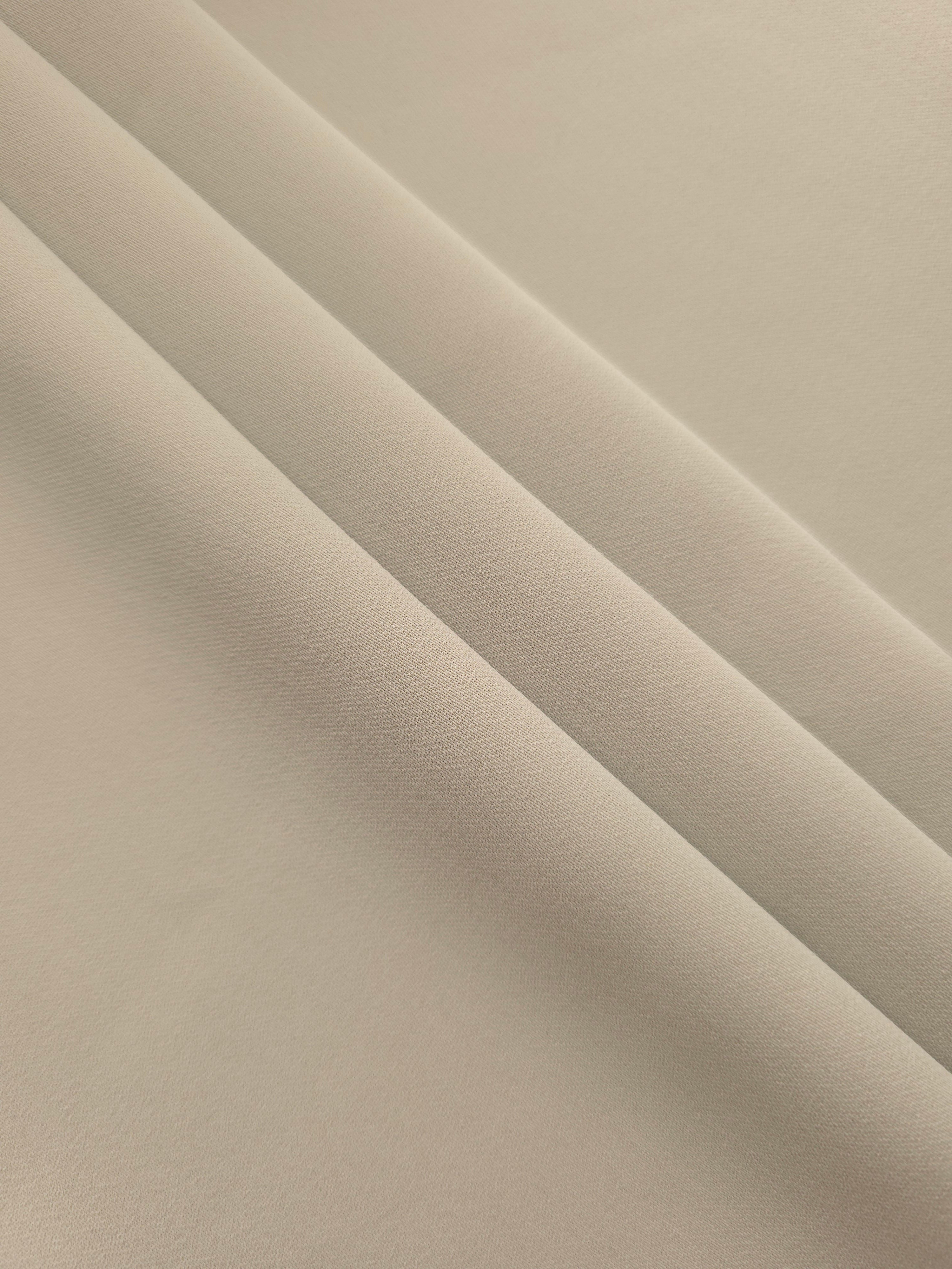 Layered Porcelain Greige Silky Italian Crepe showing soft structure in layered folds, suitable for occasion gowns, tunics and lightweight tailored pieces.