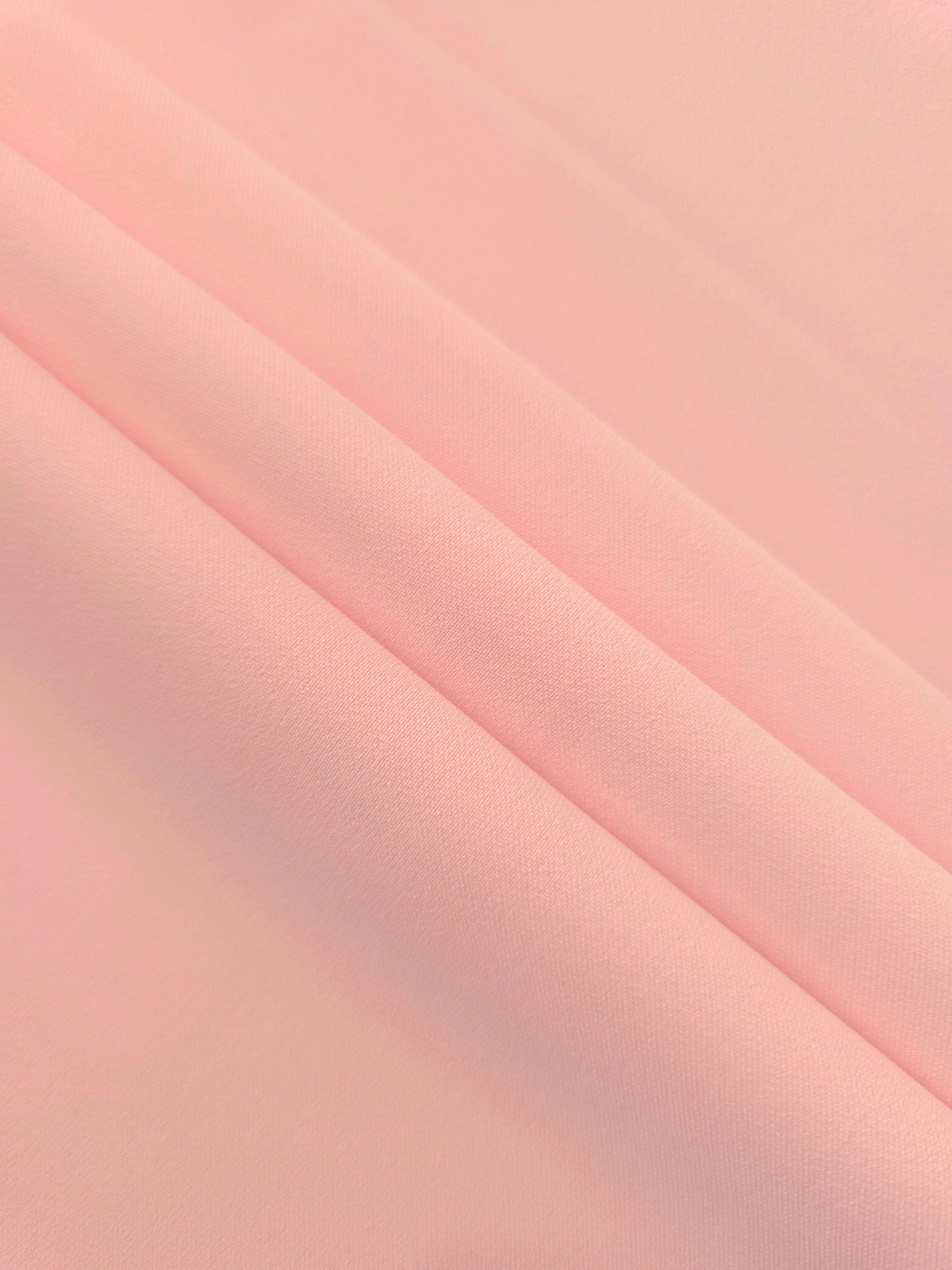 Layered Rosewater Peach Silky Italian Crepe showing soft structure in layered folds, suitable for wrap dresses, wide-leg trousers and dressy co-ords.