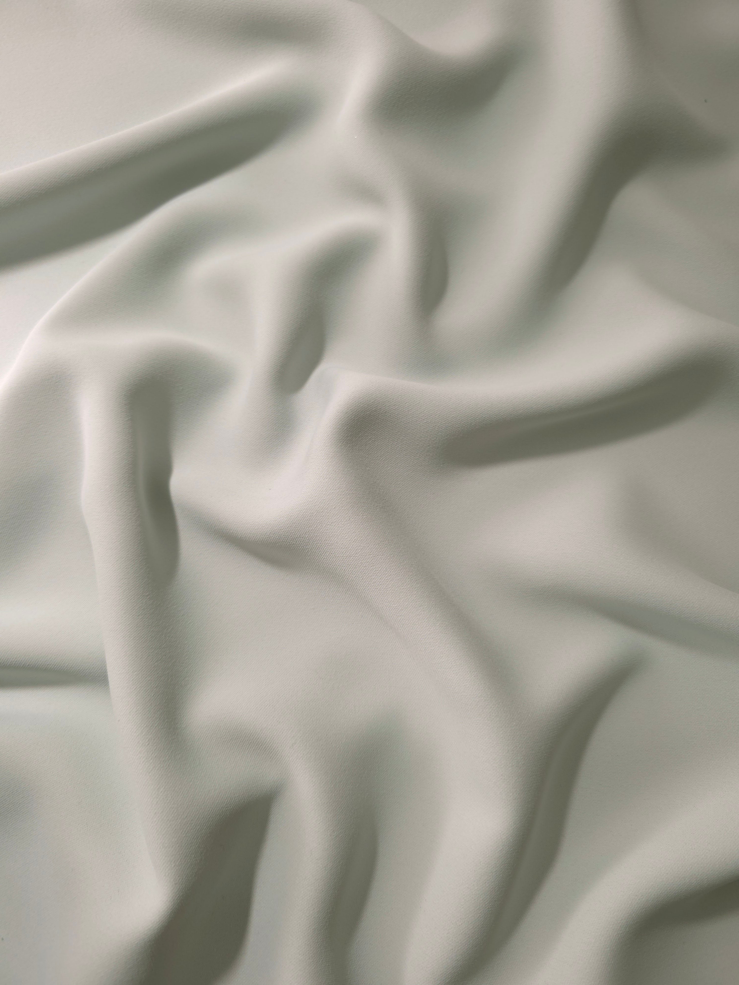 Draped Silver Mist Silky Italian Crepe showing an elegant fall through draped folds, ideal for occasion gowns, tunics and lightweight tailored pieces.