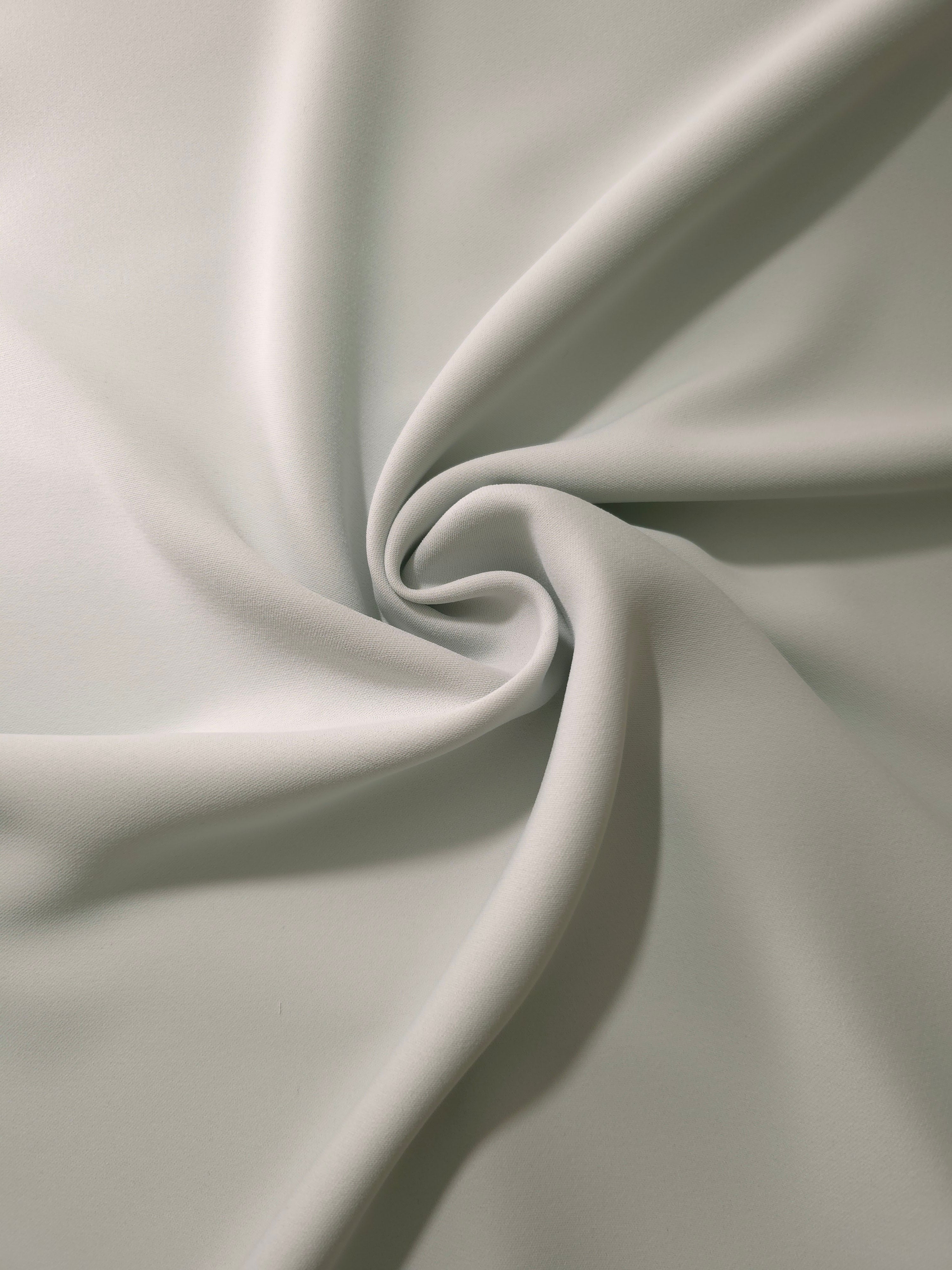 Swirled Silver Mist Silky Italian Crepe showing flowing movement in a swirl drape, versatile for blouses, midi skirts and modest dresses.