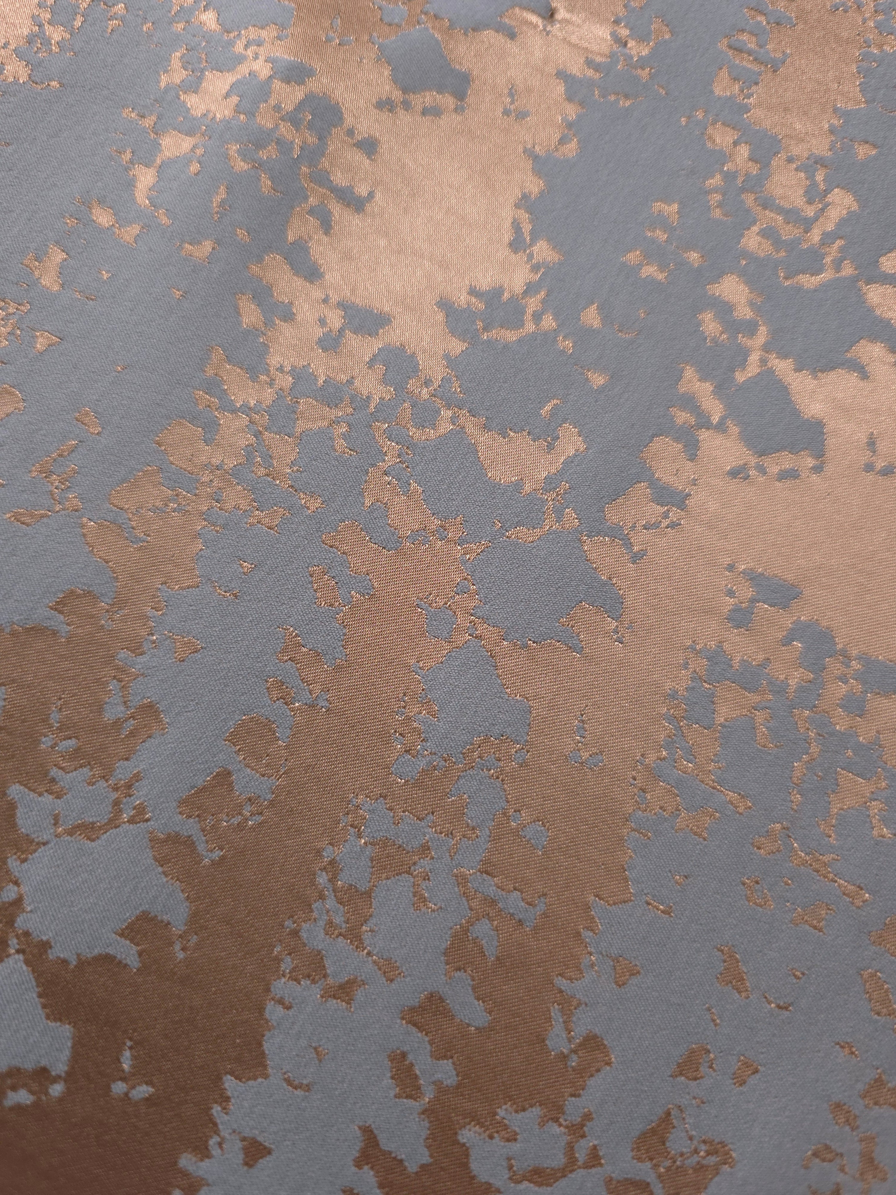 Close-up of the copper and blue-grey animal print, showing the cracked, mottled texture characteristic of this motif