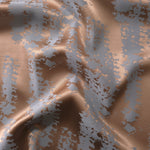 Copper and blue-grey animal print satin folded over, the mottled pattern shifting tone across the crease