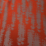 A wider section of the burnt orange and grey-mauve animal print satin, shown to judge the pattern at scale