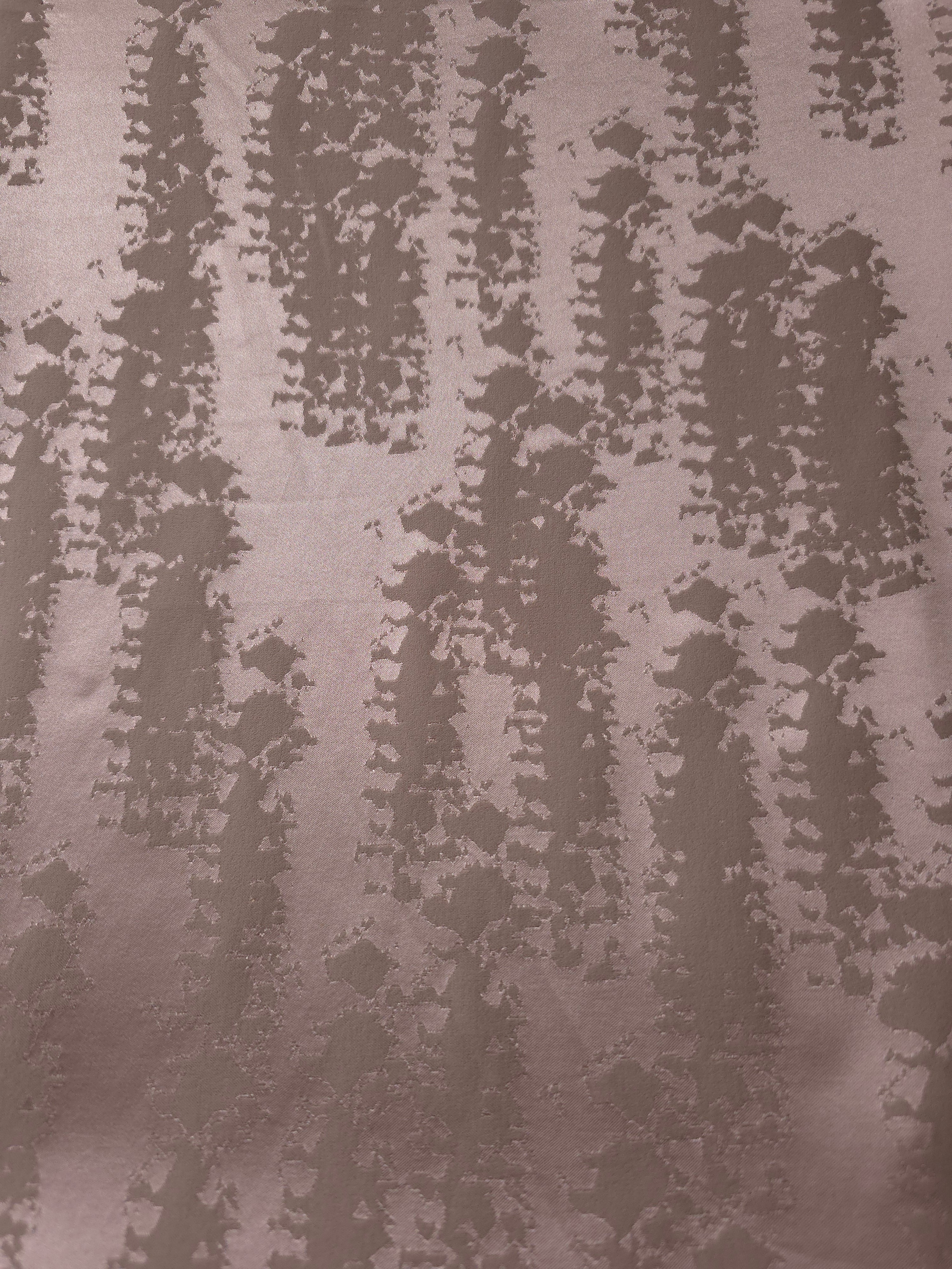 A wider cut of the mauve-rose animal print satin laid out, showing the full tonal repeat