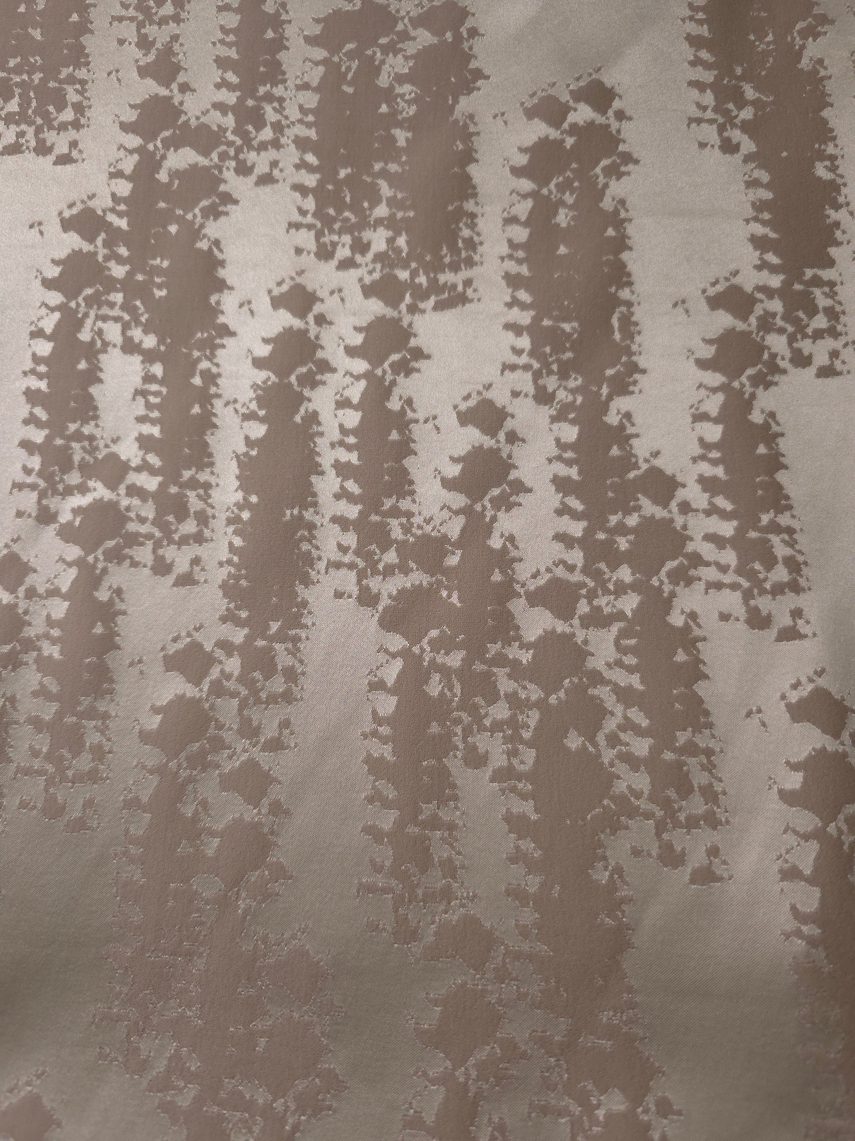 A wider view of the taupe animal print satin laid flat, showing the full tonal pattern repeat