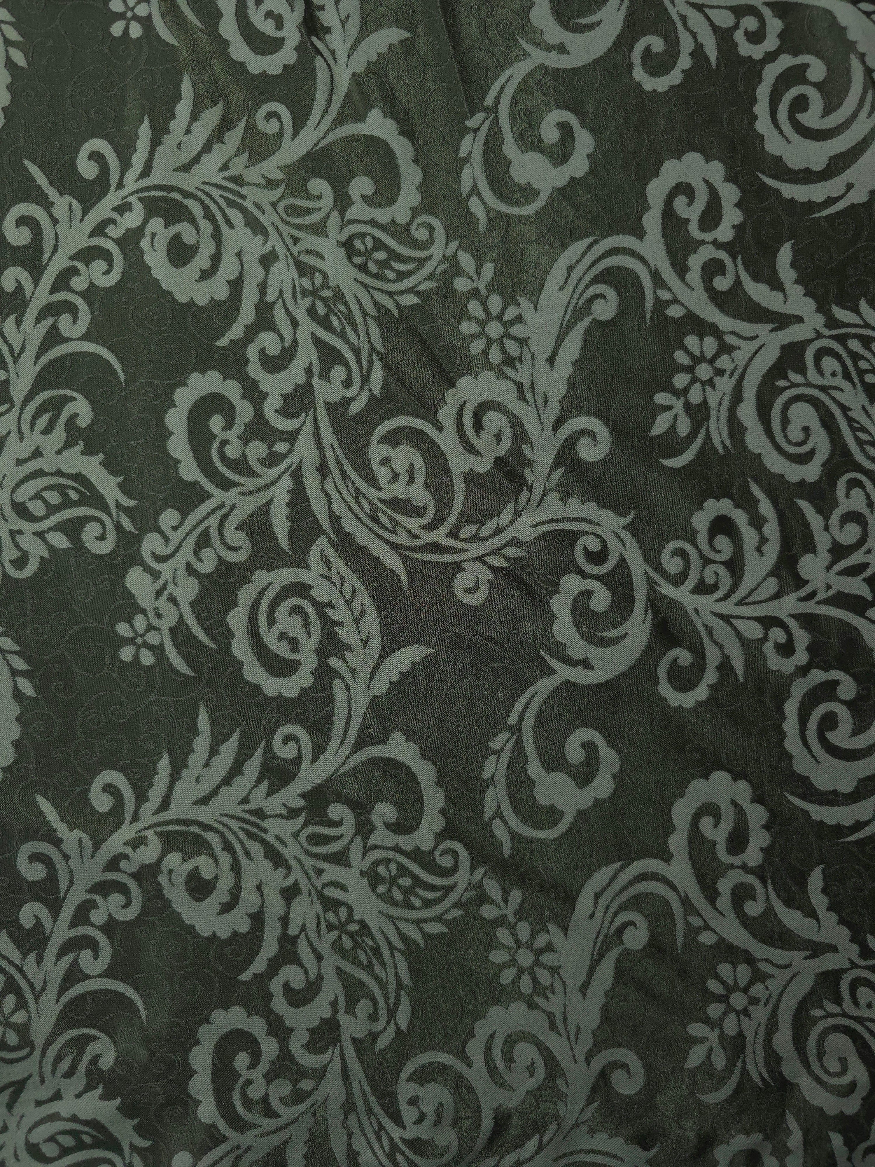 A wider view of the olive baroque satin laid flat, showing the full scroll pattern repeat