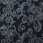 A wider view of the navy and grey baroque satin laid flat, showing the full scroll pattern repeat