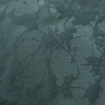 Close-up of the teal floral colorway, a finer, more intricate spray motif than the bold hibiscus and pansy designs