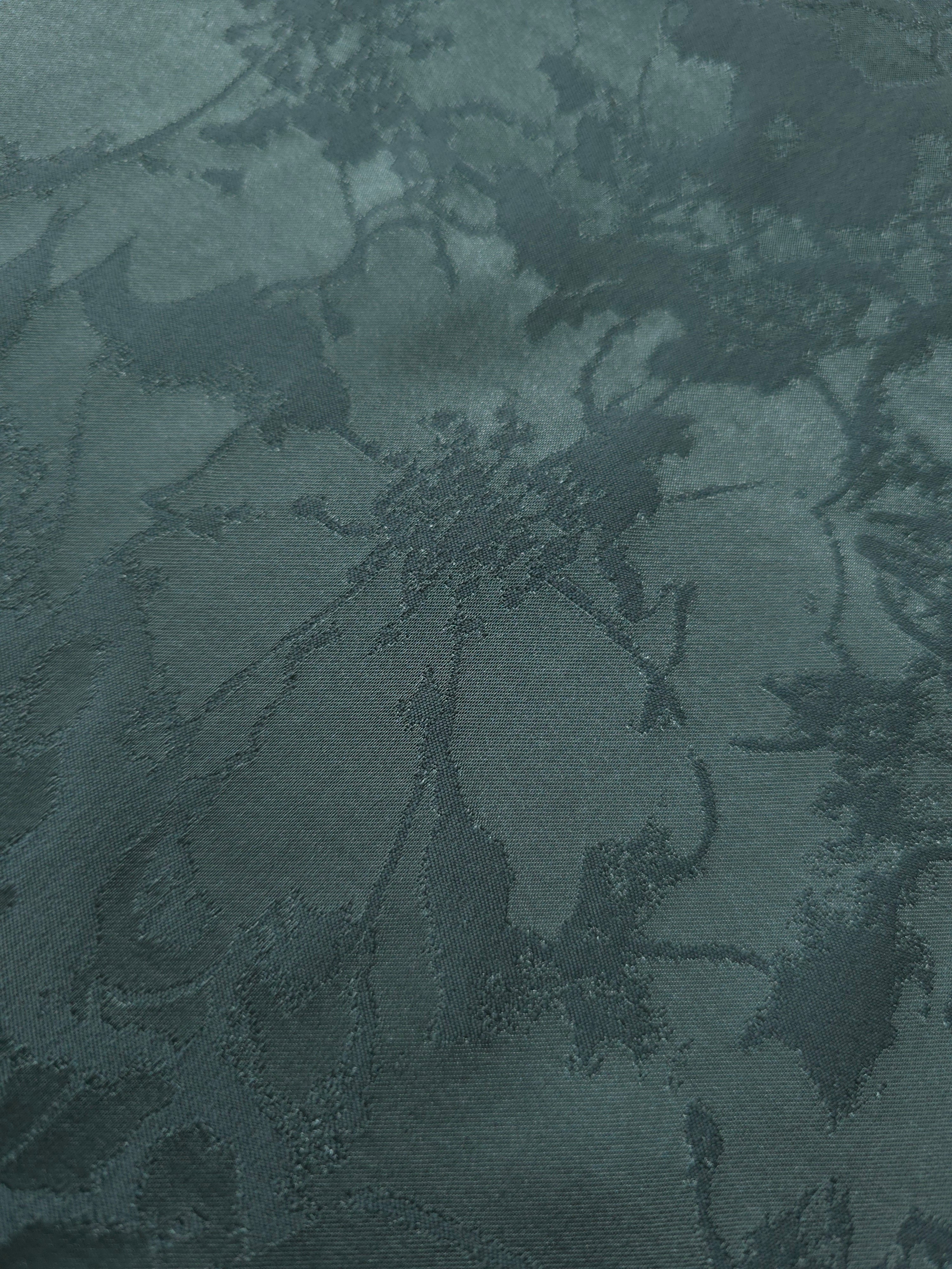 Close-up of the teal floral colorway, a finer, more intricate spray motif than the bold hibiscus and pansy designs