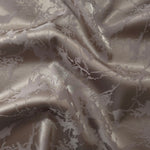 Taupe-grey satin folded softly, the same delicate floral spray reading warmer than the teal colorway