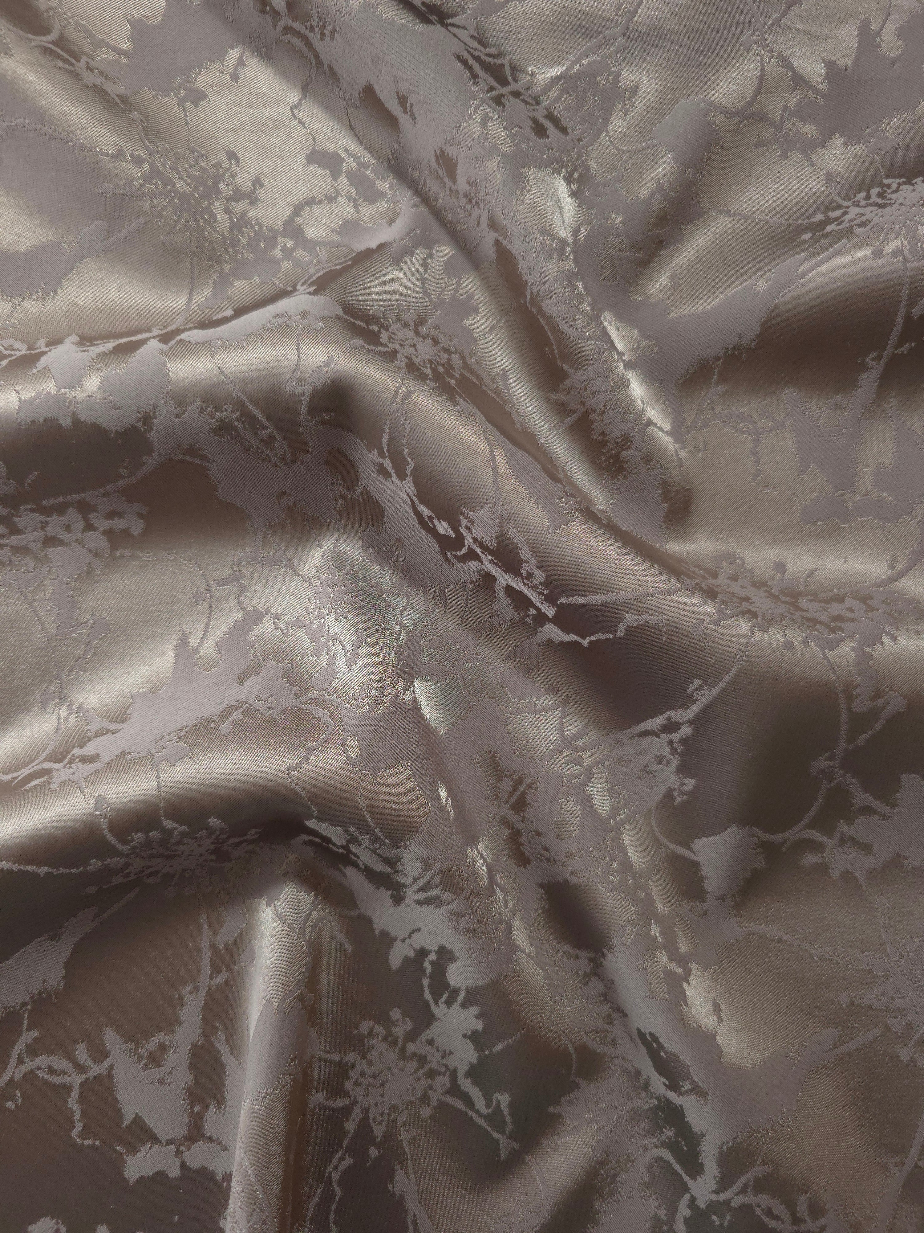 Taupe-grey satin folded softly, the same delicate floral spray reading warmer than the teal colorway