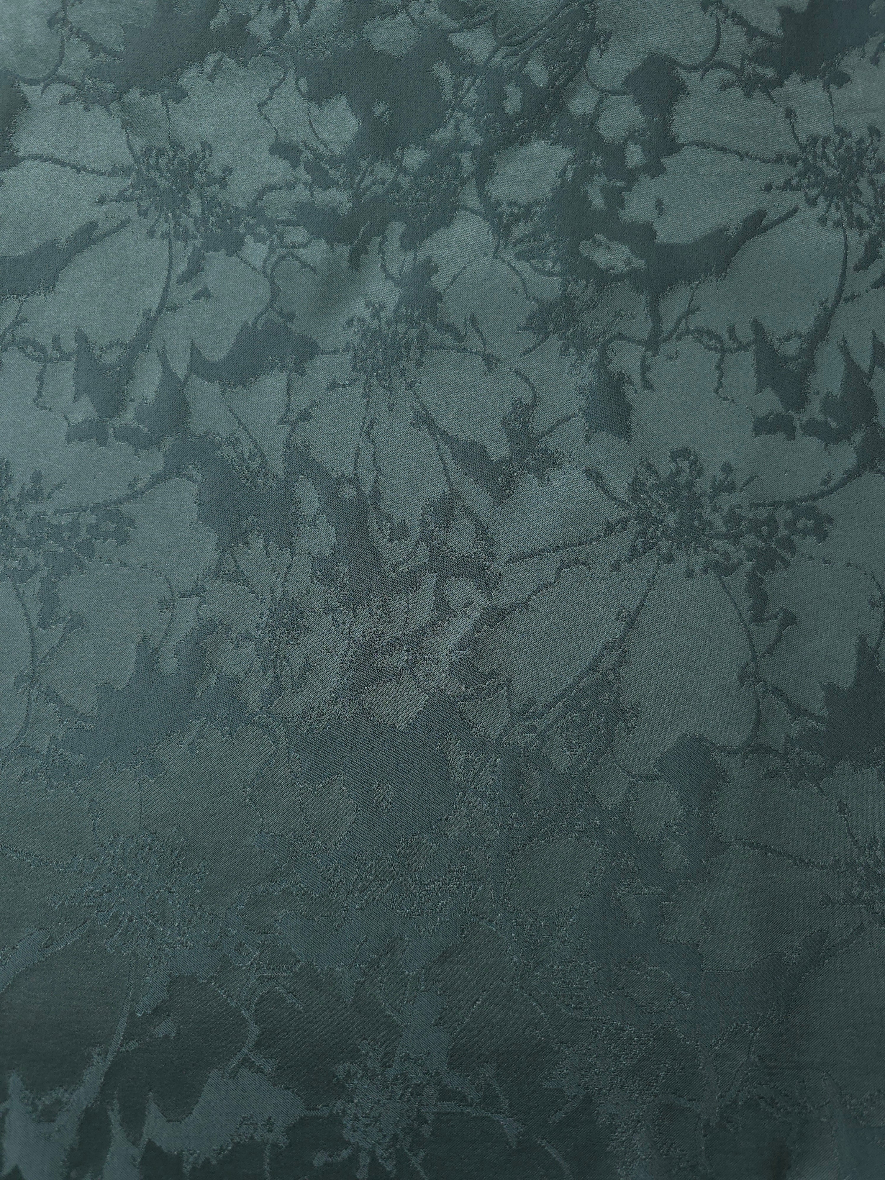 A wider cut of the teal floral satin laid flat, showing the full scale of the spray pattern