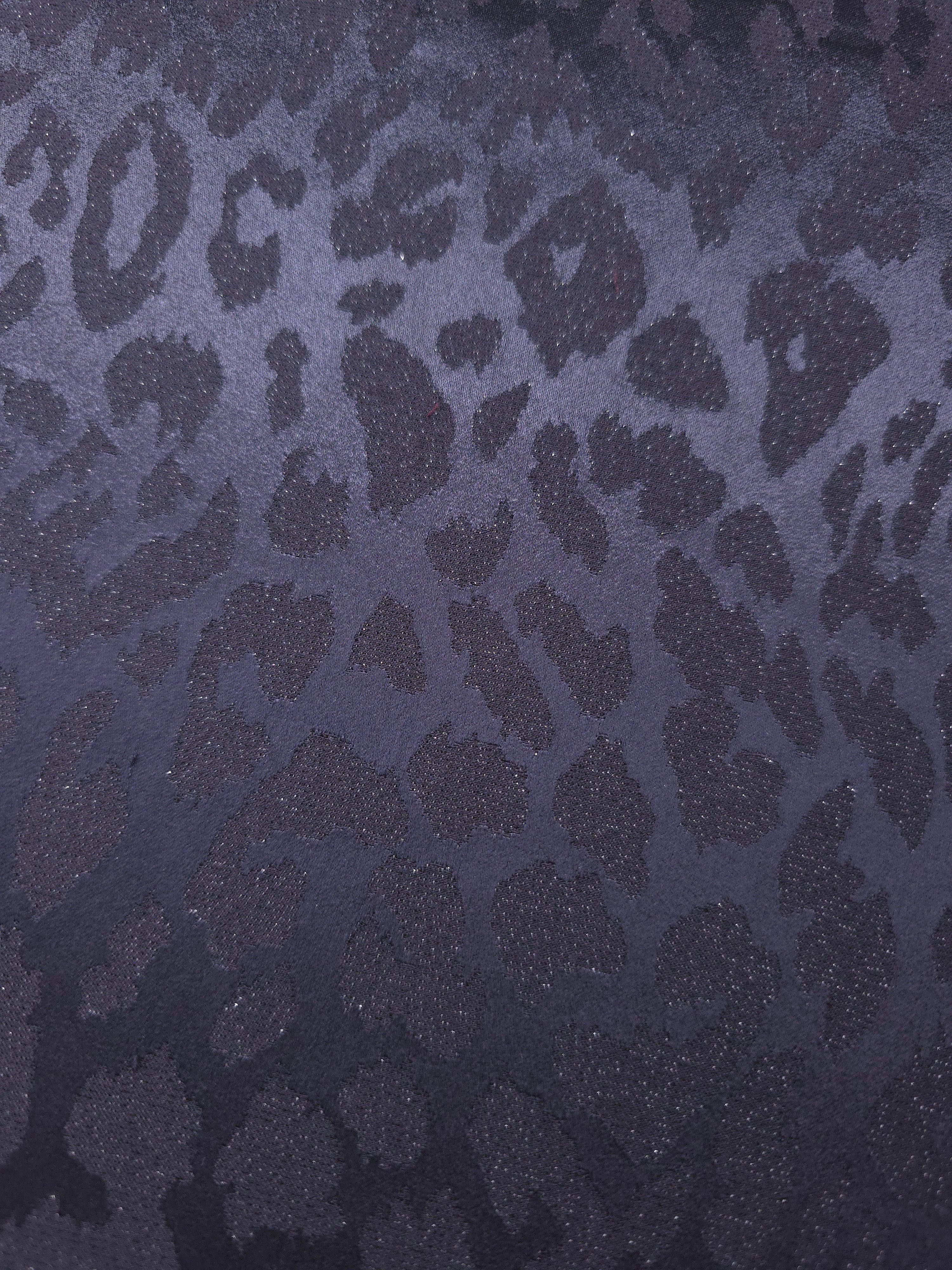 Close-up of leopard metallic jacquard showing pattern-only shimmer on woven fabric.
