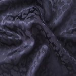 Wave fold of leopard metallic motif jacquard showing shimmer for dresses and statement layers.