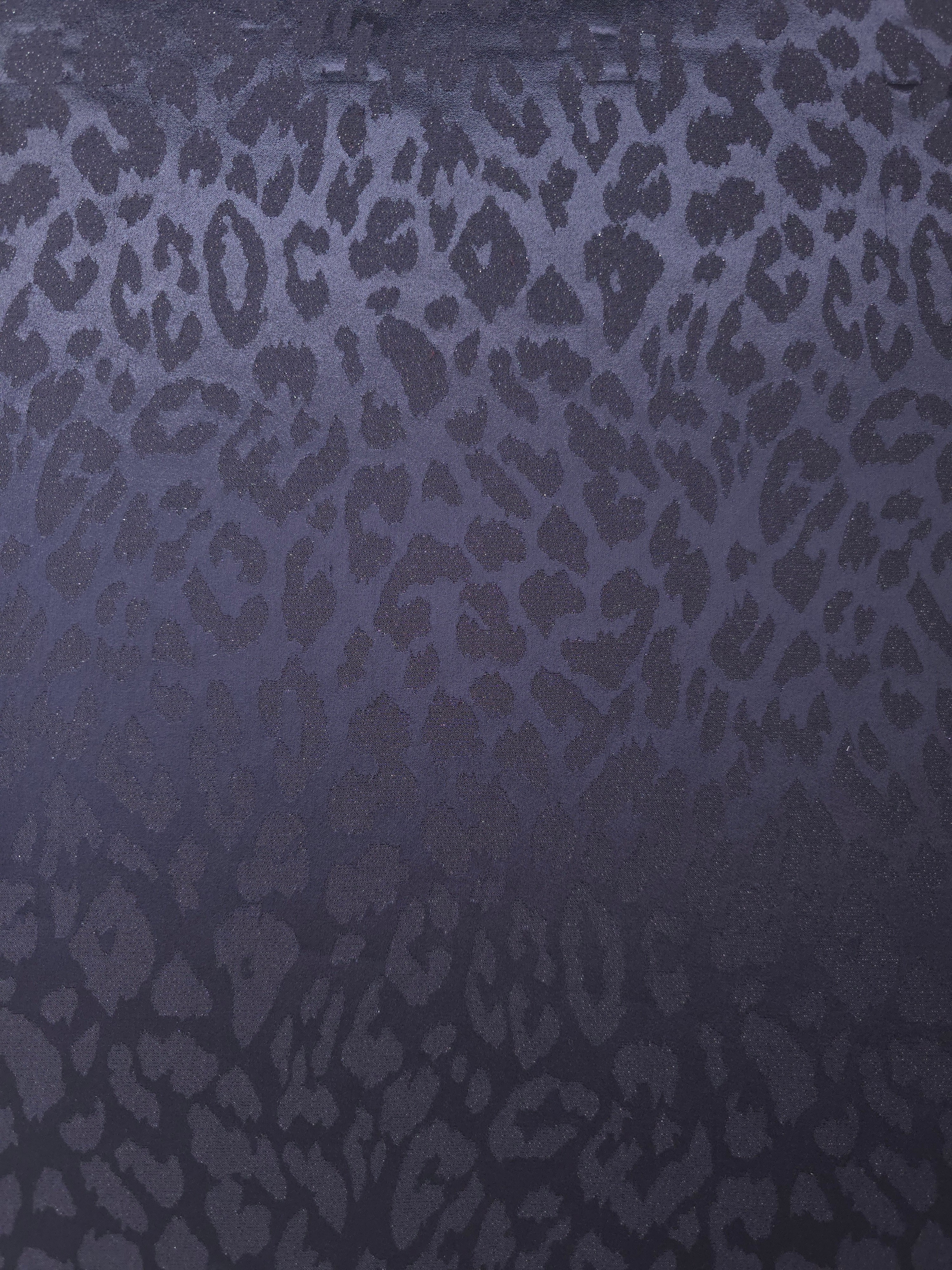 Wide view of leopard metallic motif woven jacquard fabric for dressmaking.