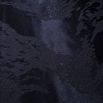 Close-up of metallic wave jacquard showing raised motif and pattern-only shine.