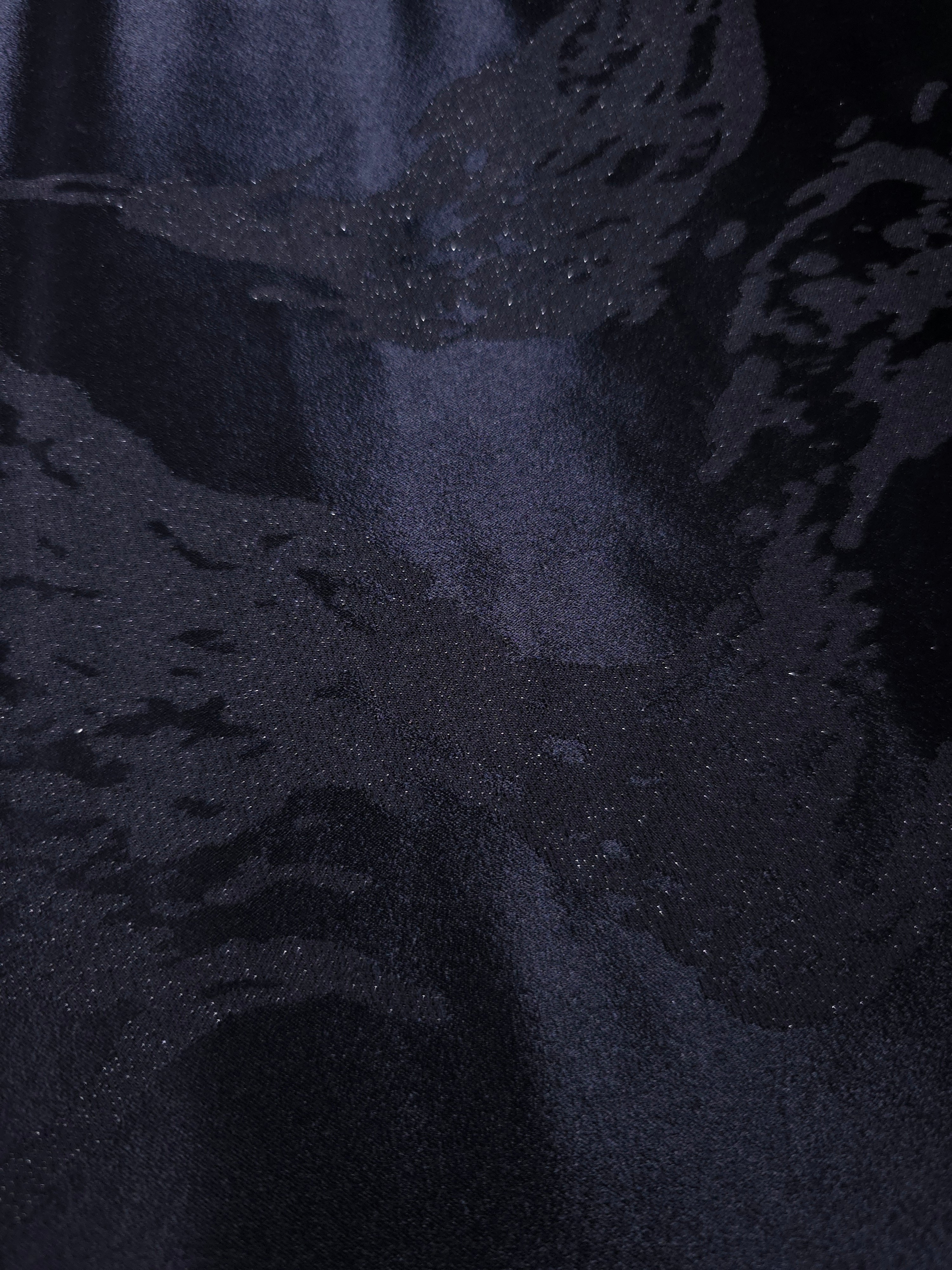 Close-up of metallic wave jacquard showing raised motif and pattern-only shine.