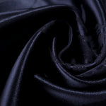 Close drape of metallic wave motif jacquard showing fold detail and shimmer.