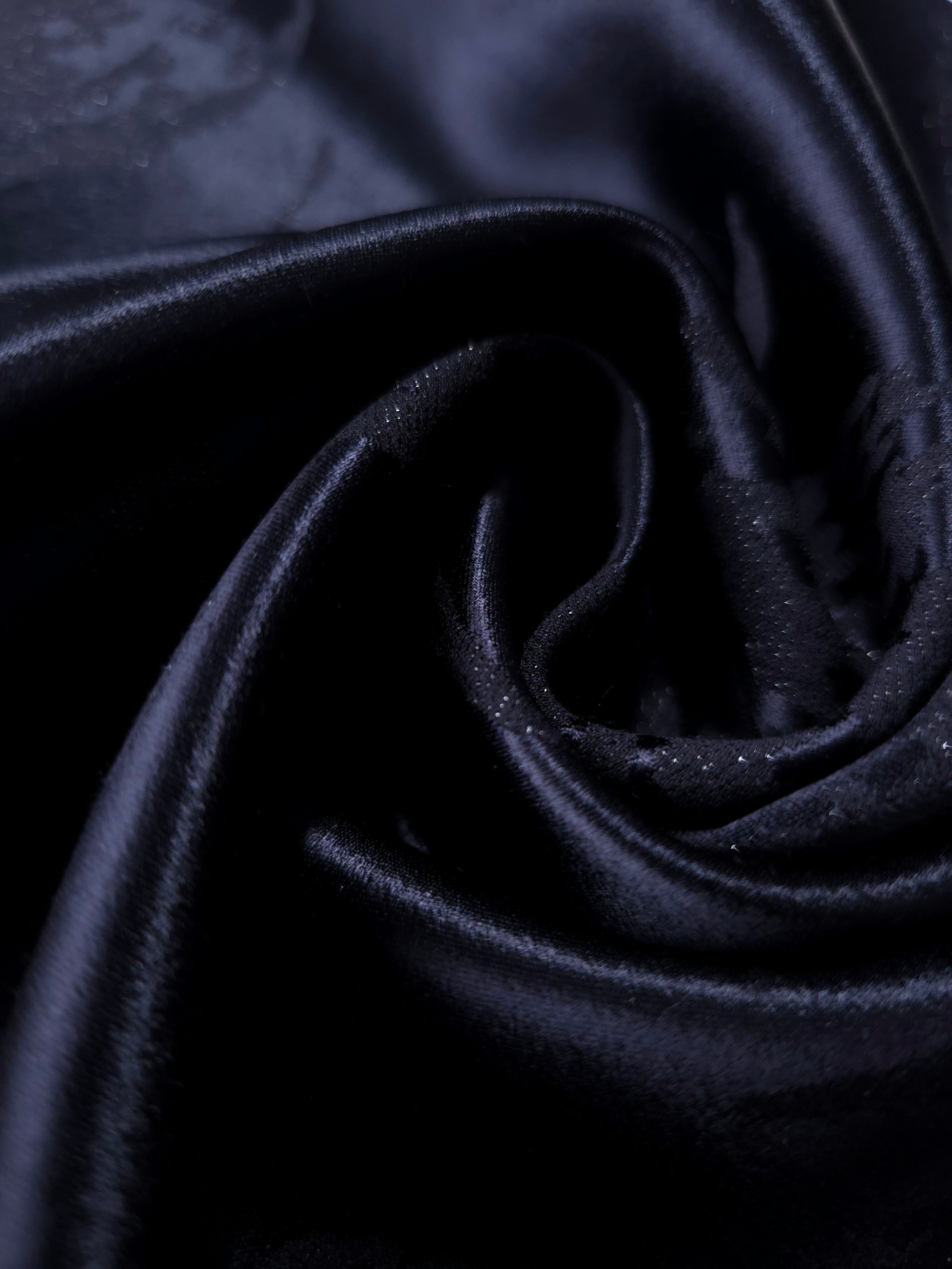 Close drape of metallic wave motif jacquard showing fold detail and shimmer.