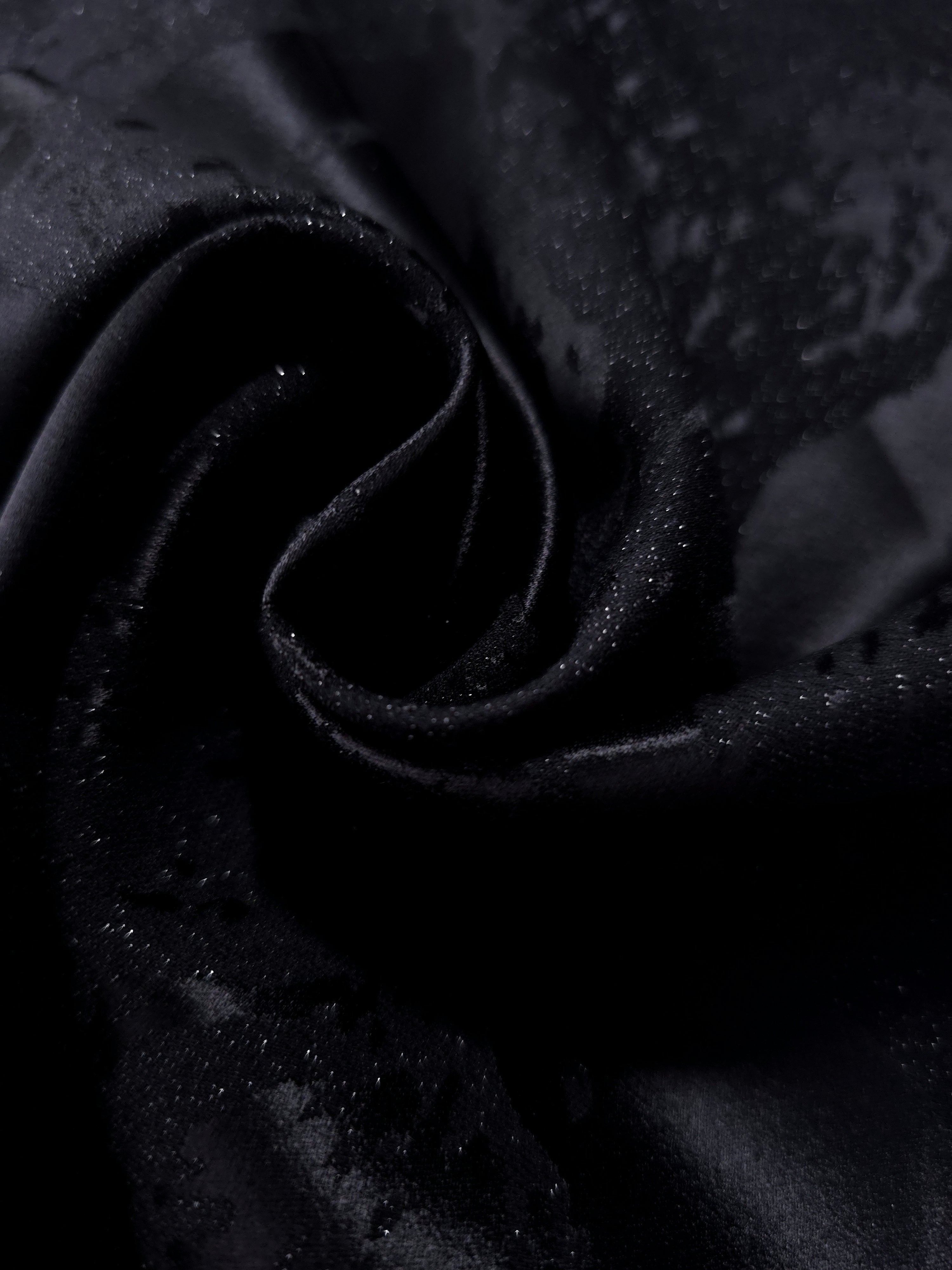 Close drape of alternate metallic wave jacquard showing raised texture and folds.