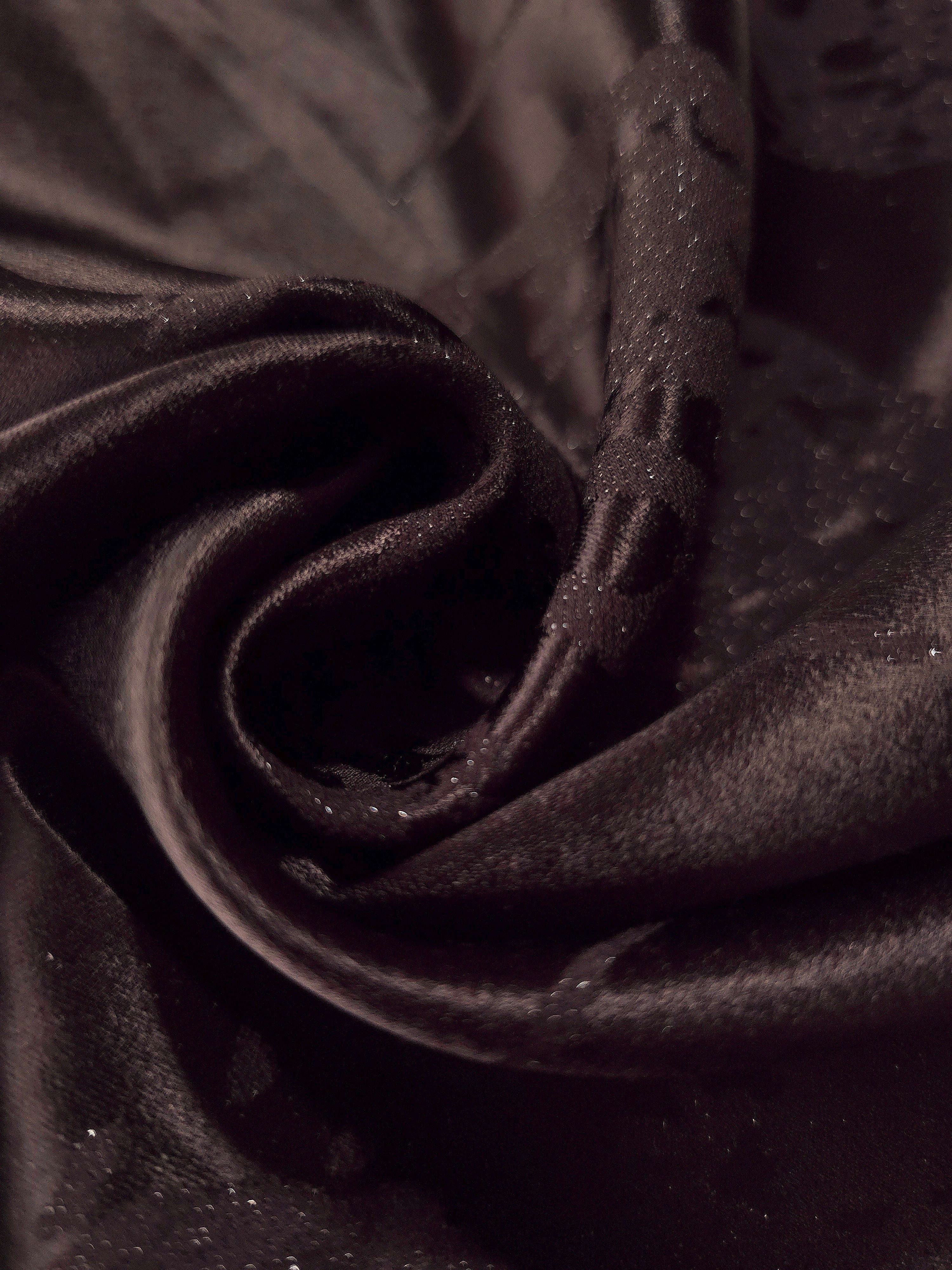 Close drape of dark brown metallic wave jacquard showing woven texture and shimmer.