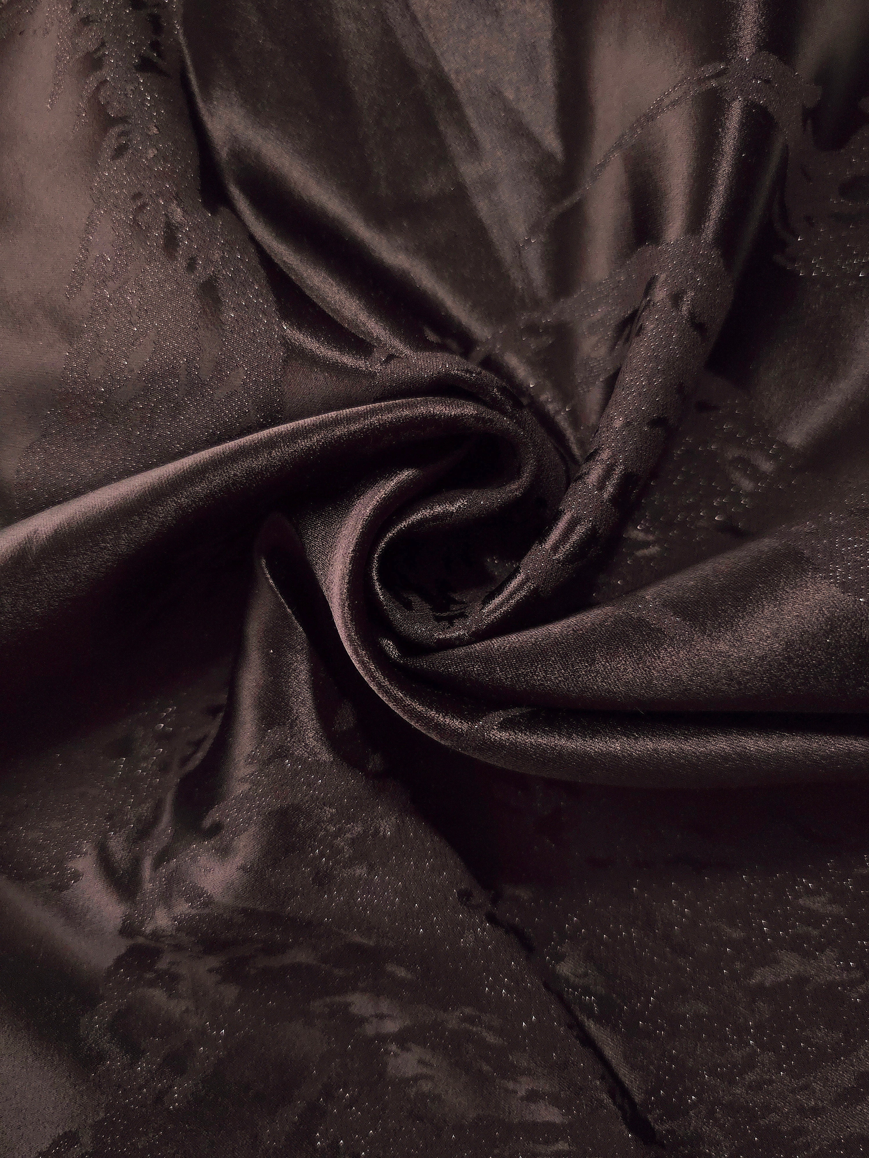 Draped dark brown metallic wave jacquard with soft movement for dresses and skirts.