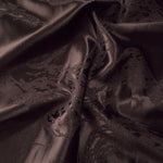 Wave fold of dark brown metallic wave jacquard showing raised shimmer motif.