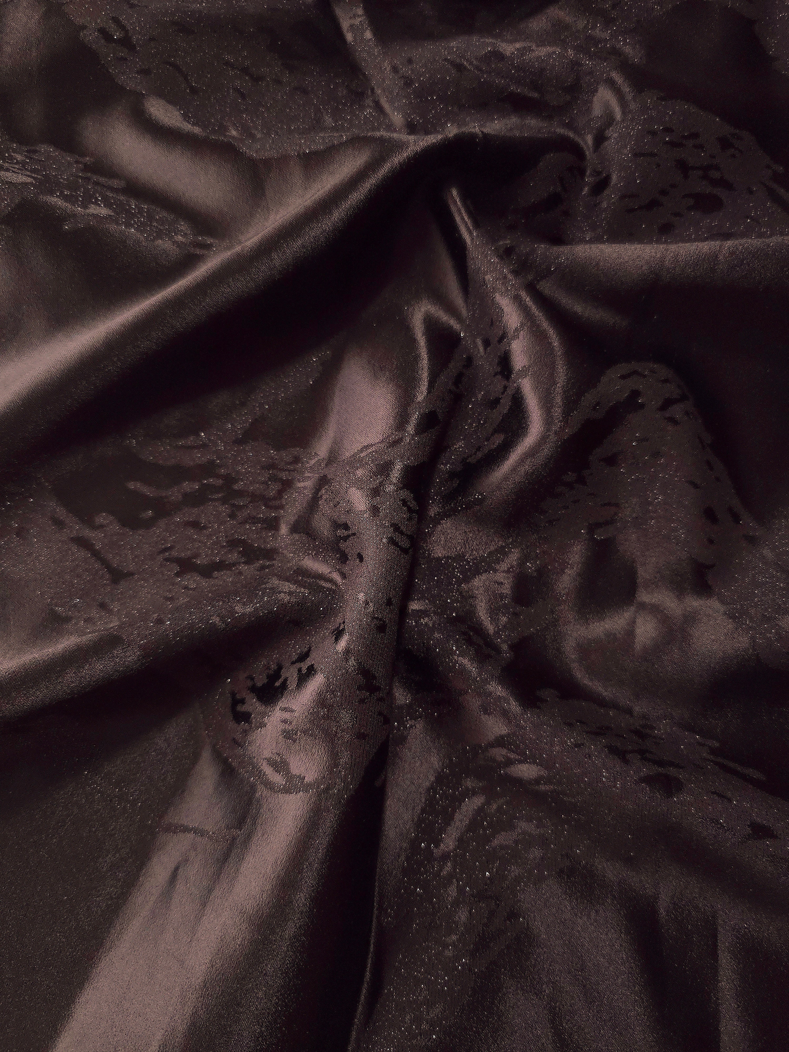 Wave fold of dark brown metallic wave jacquard showing raised shimmer motif.