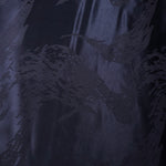 Wide view of metallic wave motif woven jacquard fabric for garment planning.