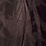 Wide view of dark brown metallic wave motif woven jacquard fabric for dress panels.