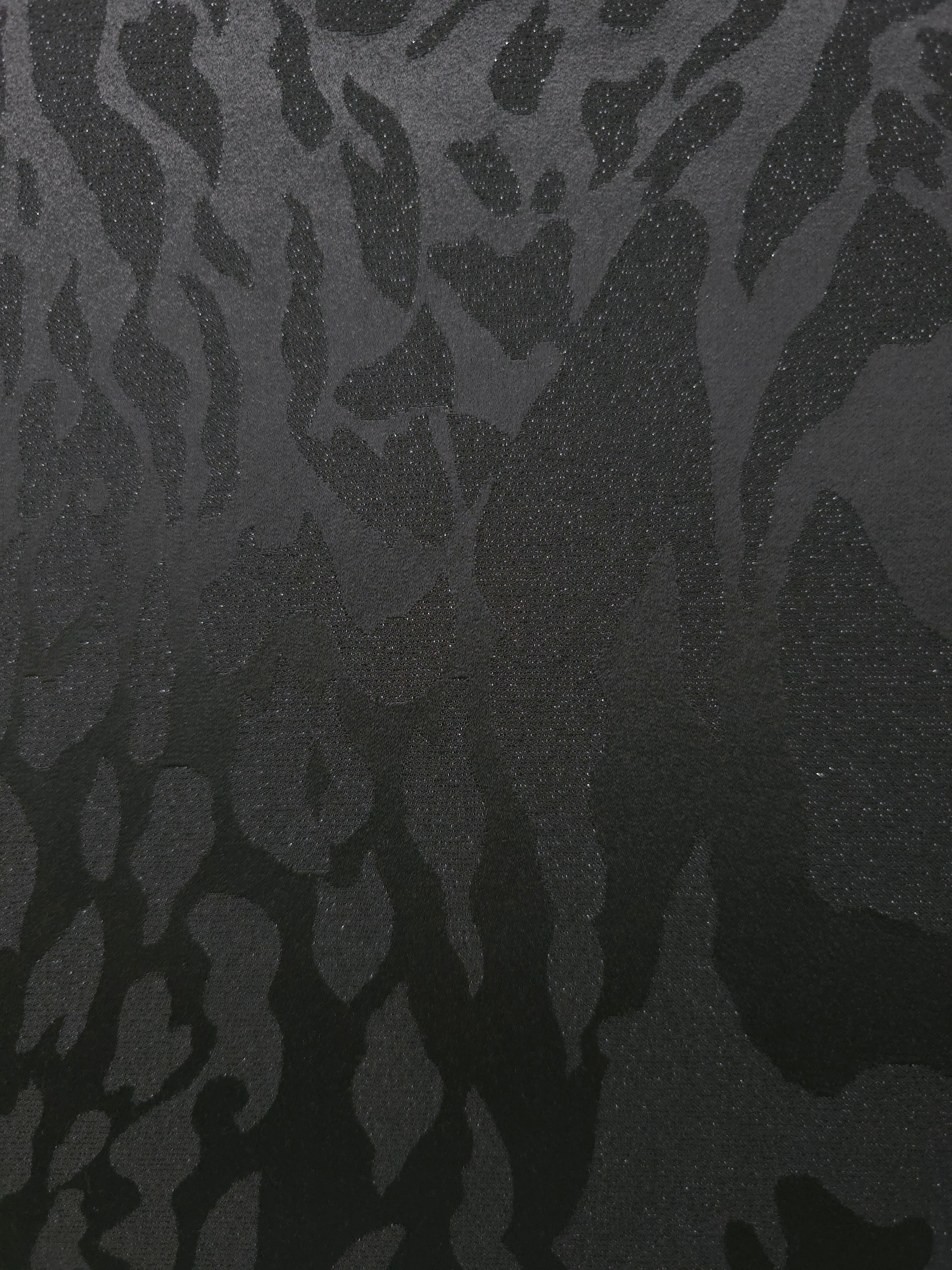 Close-up of zebra metallic jacquard showing pattern-only shimmer on woven fabric.