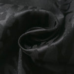 Close drape of zebra metallic jacquard showing raised woven motif and shine.