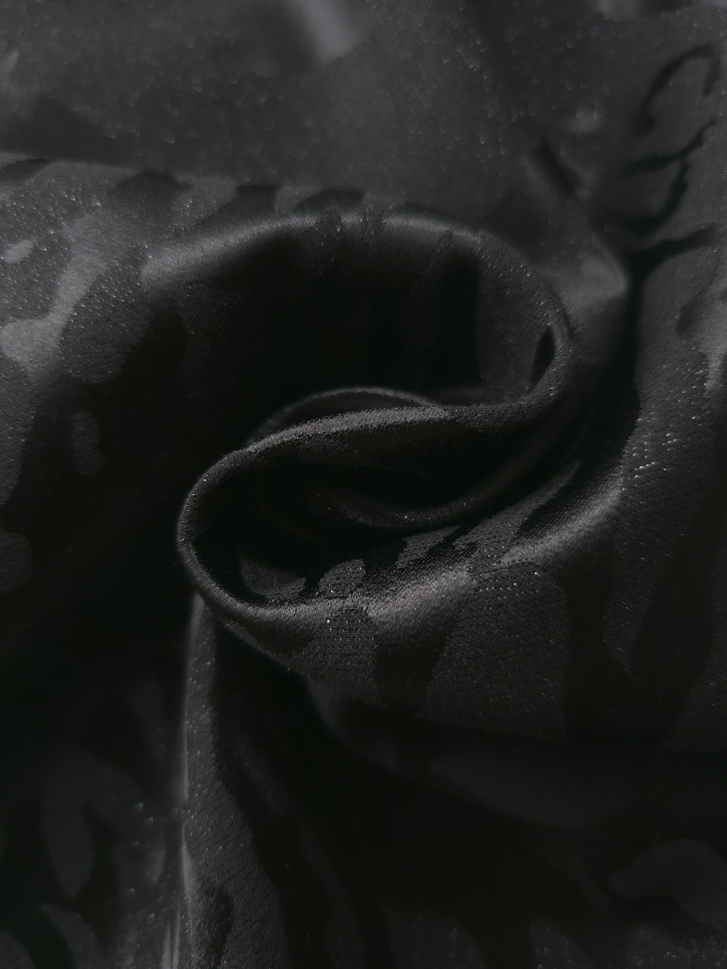 Close drape of zebra metallic jacquard showing raised woven motif and shine.