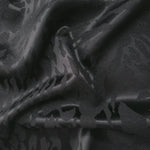 Wave fold of zebra metallic motif jacquard showing shimmer for statement garments.
