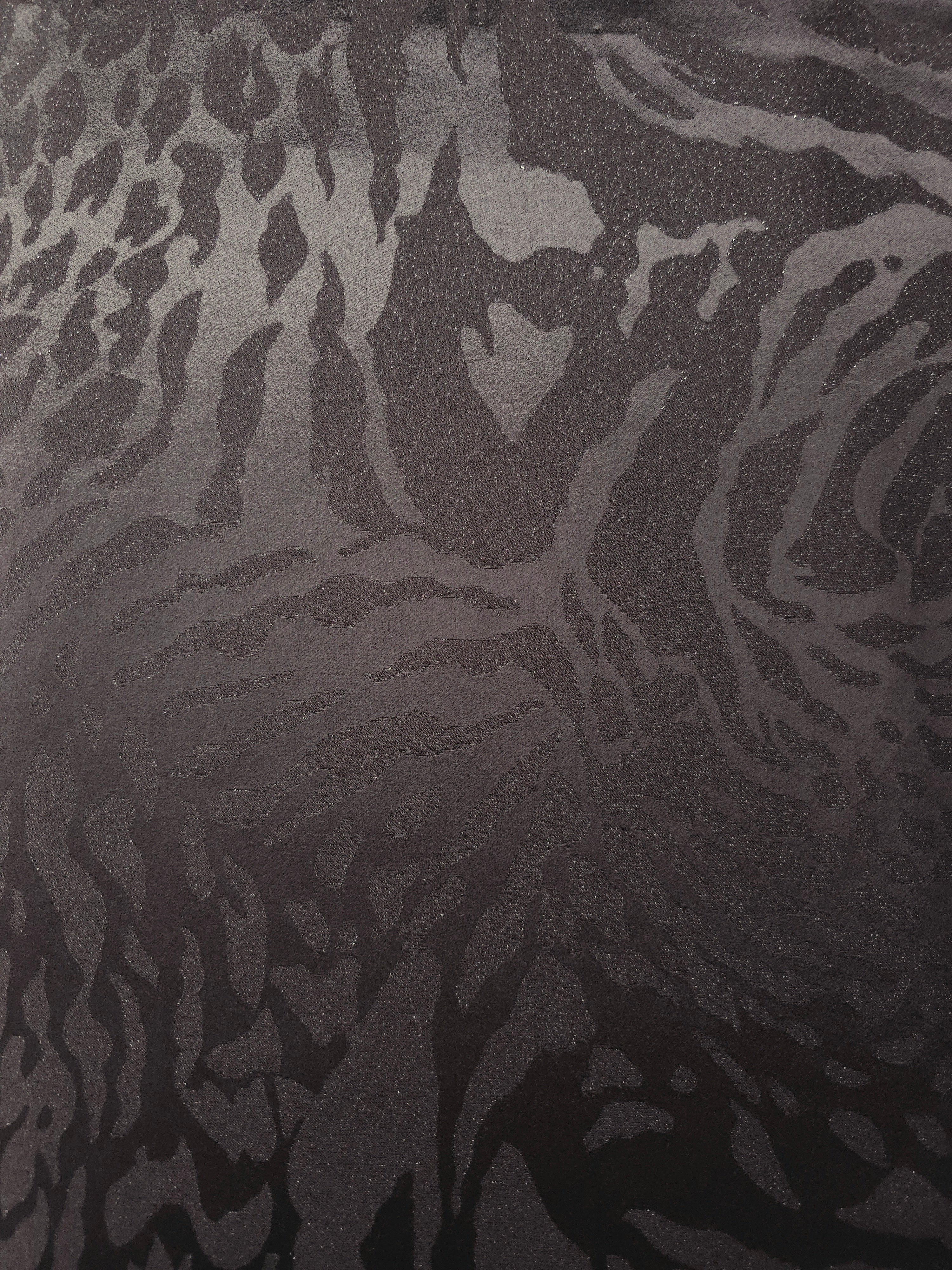Wide view of second zebra metallic motif woven jacquard fabric for garment panels.
