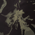 Close-up of the black graphic line colorway, an abstract fractured-splatter motif unlike any other design in this line