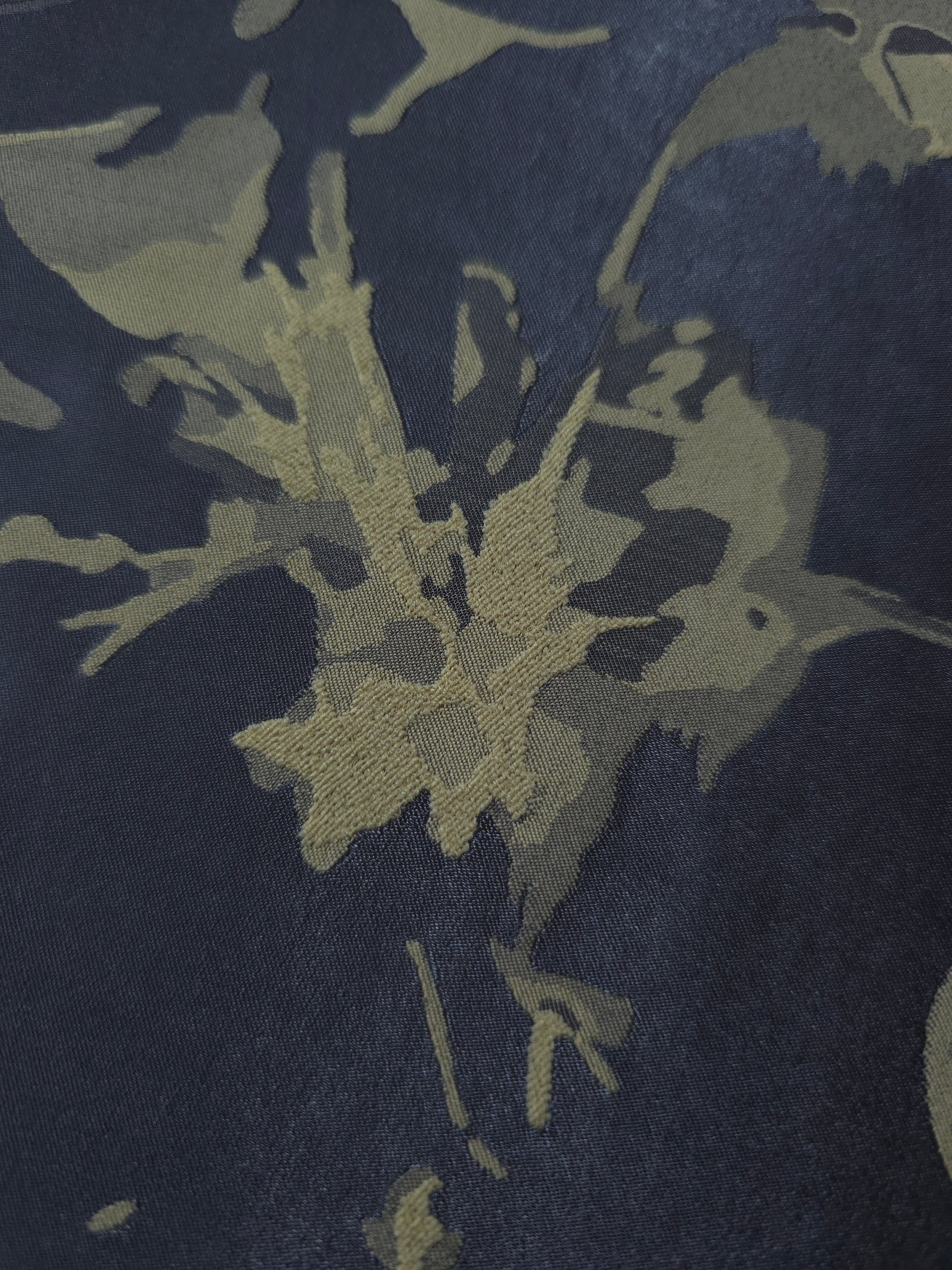 Close-up of the navy-charcoal graphic line colorway, blending cooler and warmer tones in one abstract print
