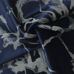 Navy graphic line satin draped loosely, suited to buyers wanting a modern, abstract print
