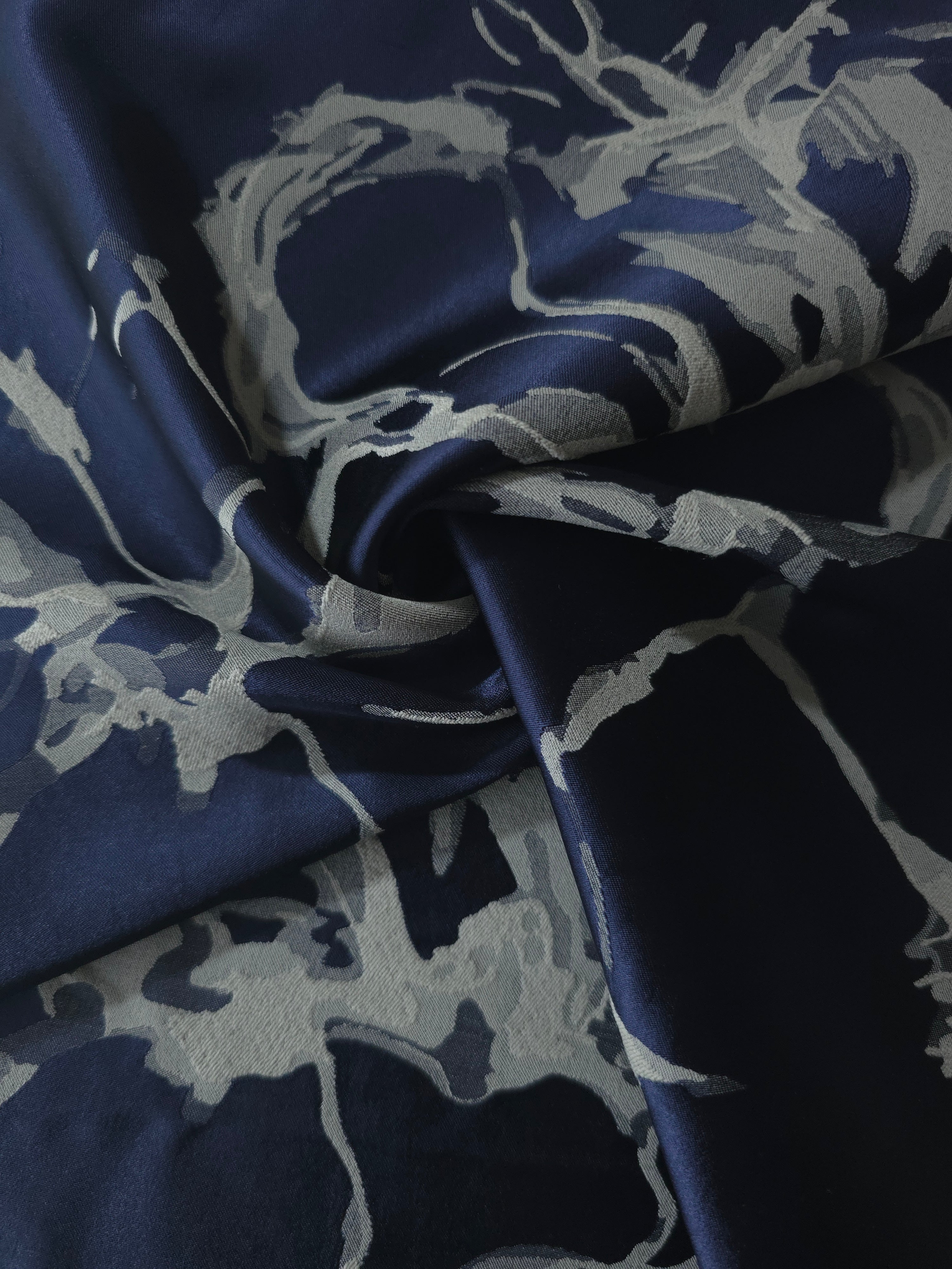 Navy graphic line satin draped loosely, suited to buyers wanting a modern, abstract print