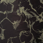 A wider cut of the black and sage-olive graphic line satin, shown to see the abstract pattern at scale