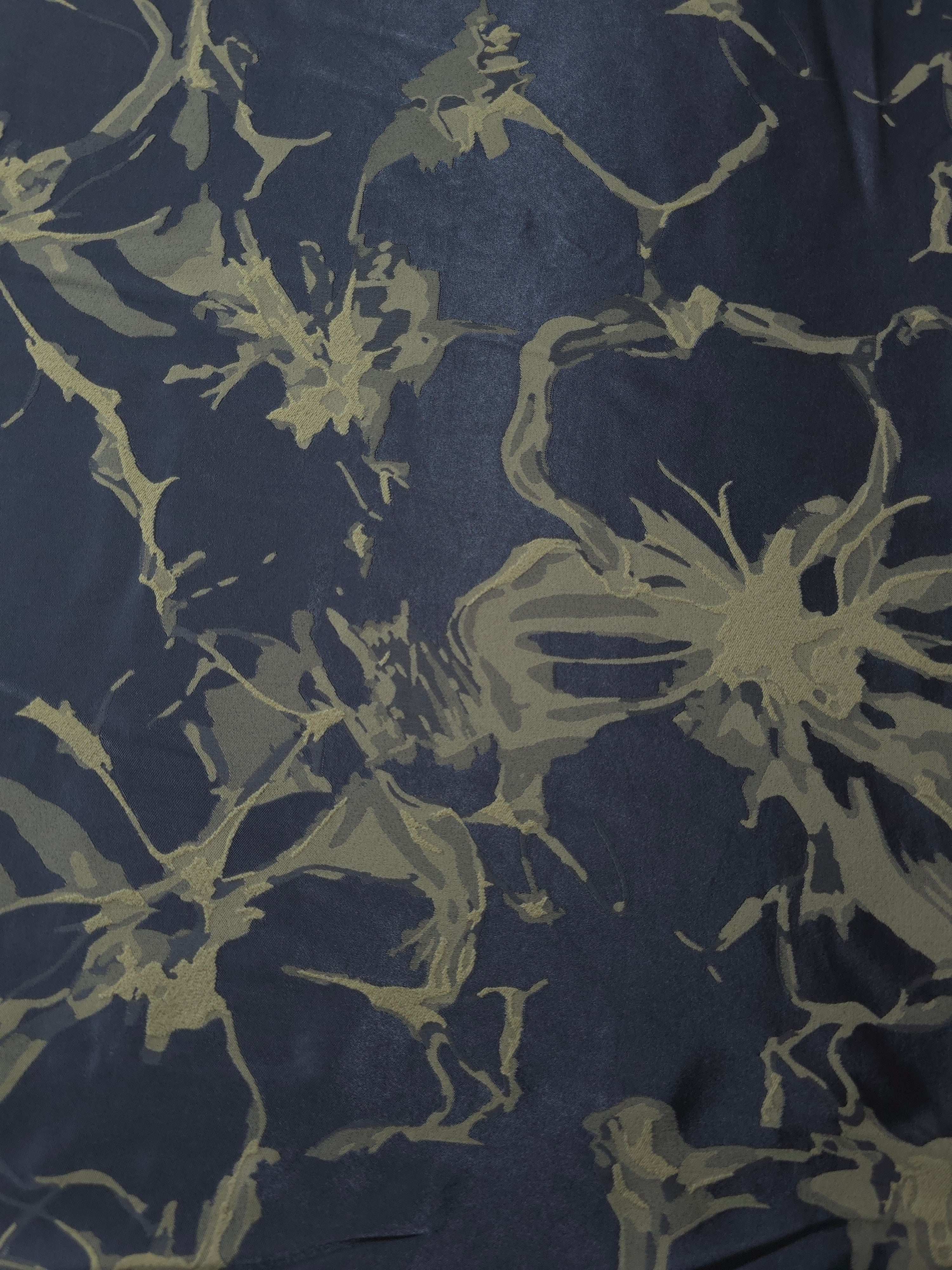 A wider section of the navy-charcoal and olive-tan graphic line satin, shown to judge the abstract pattern at scale