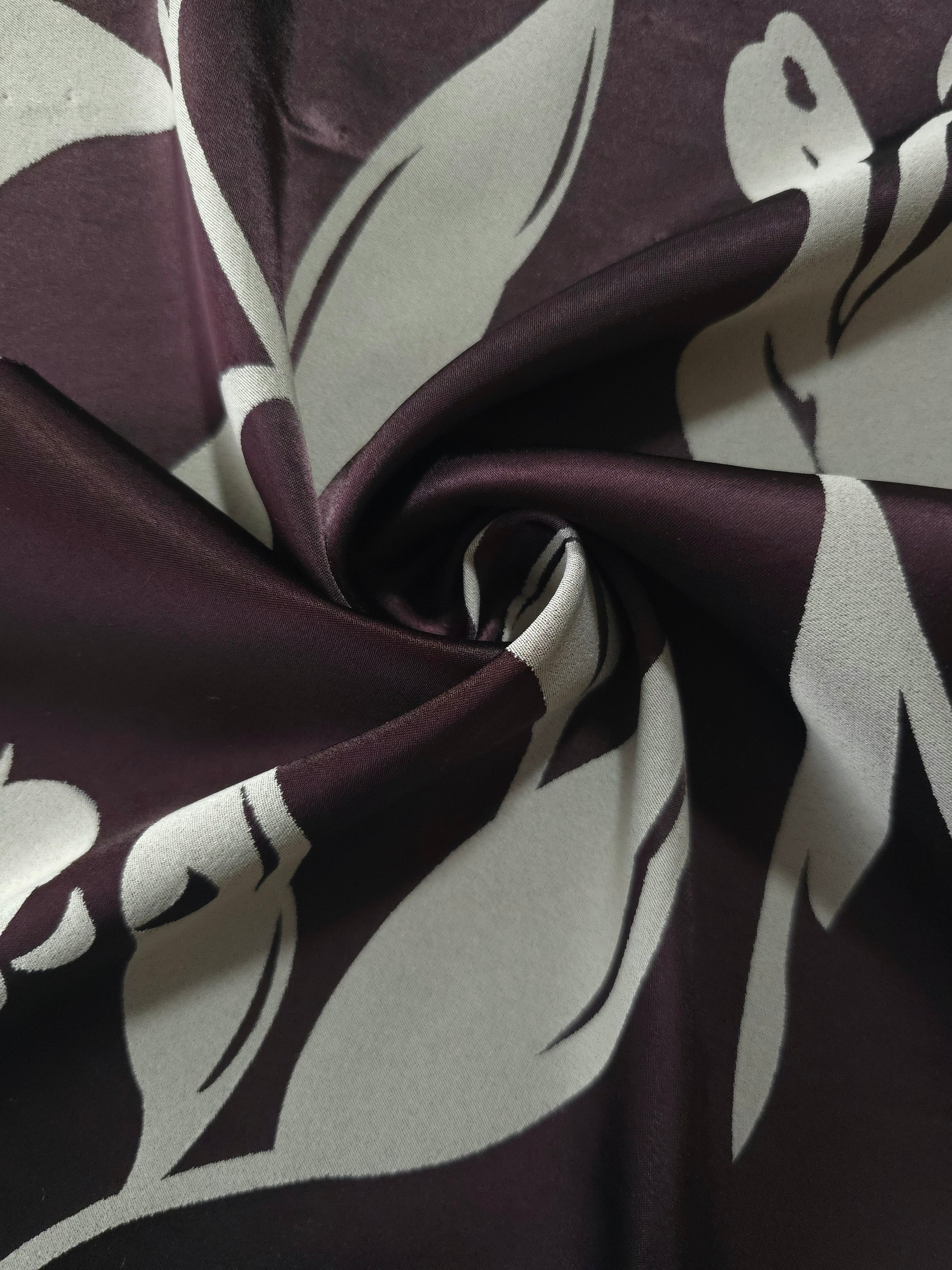 Eggplant hibiscus flower satin draped to show its glossy movement against the sage petal detail