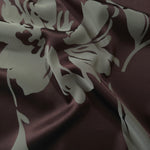 Wine-toned satin folded over, the sage-grey hibiscus petals standing out boldly against the burgundy base